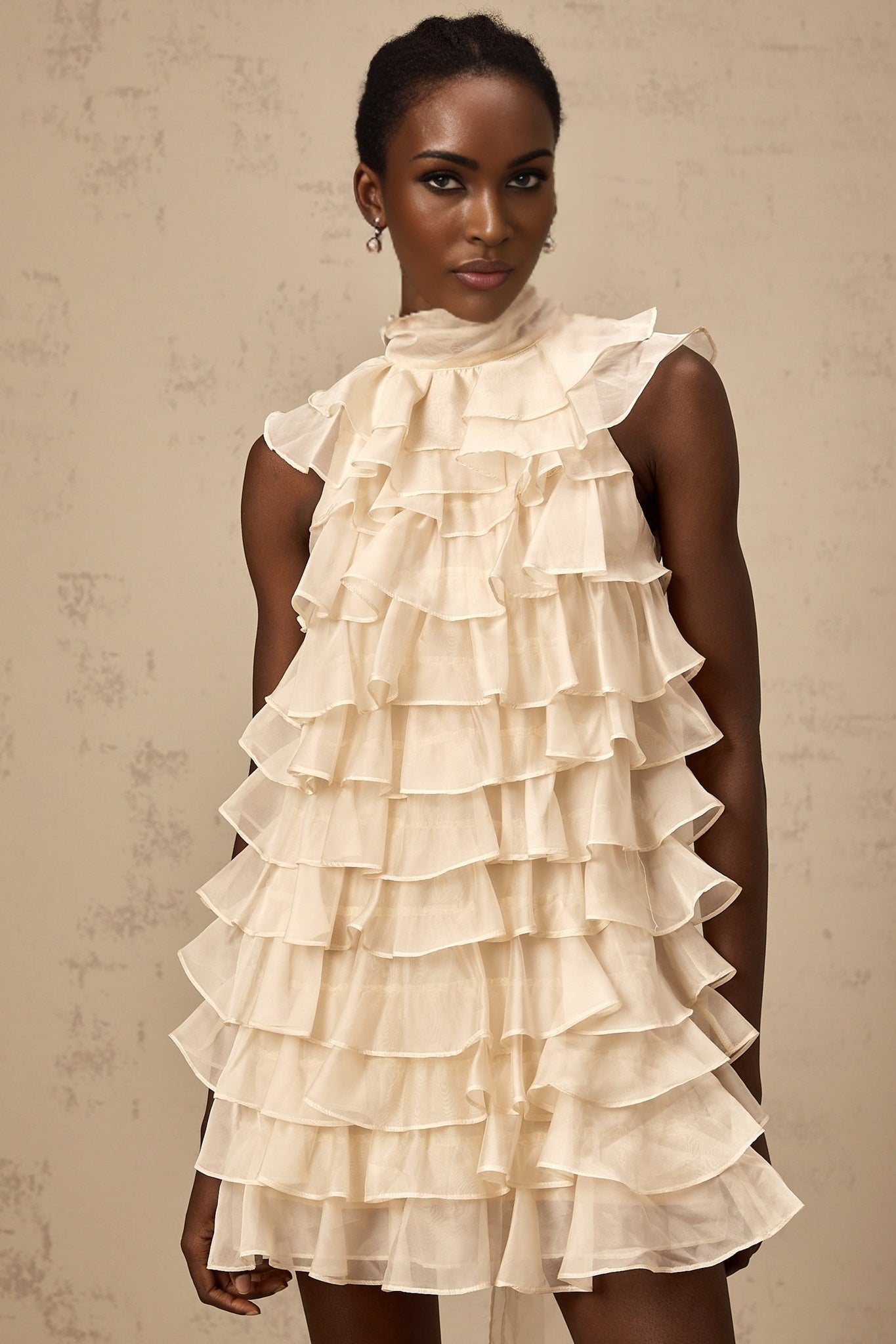 A sleeveless mini dress with tiered flounce design named Jessica featuring multiple ruffled layers and a short hemline