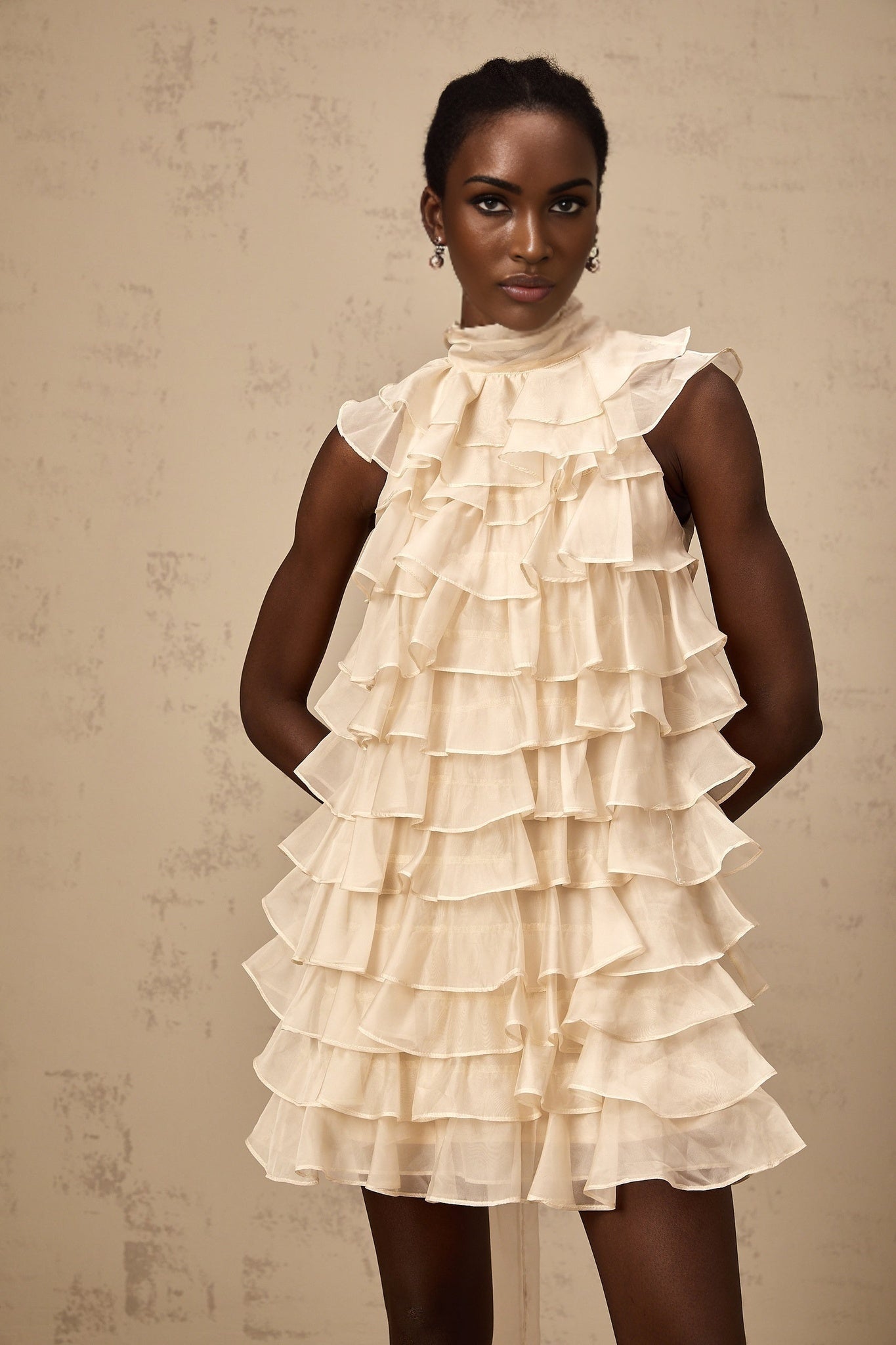 A sleeveless mini dress with tiered flounce details named Jessica featuring multiple layered ruffles on a short skirt