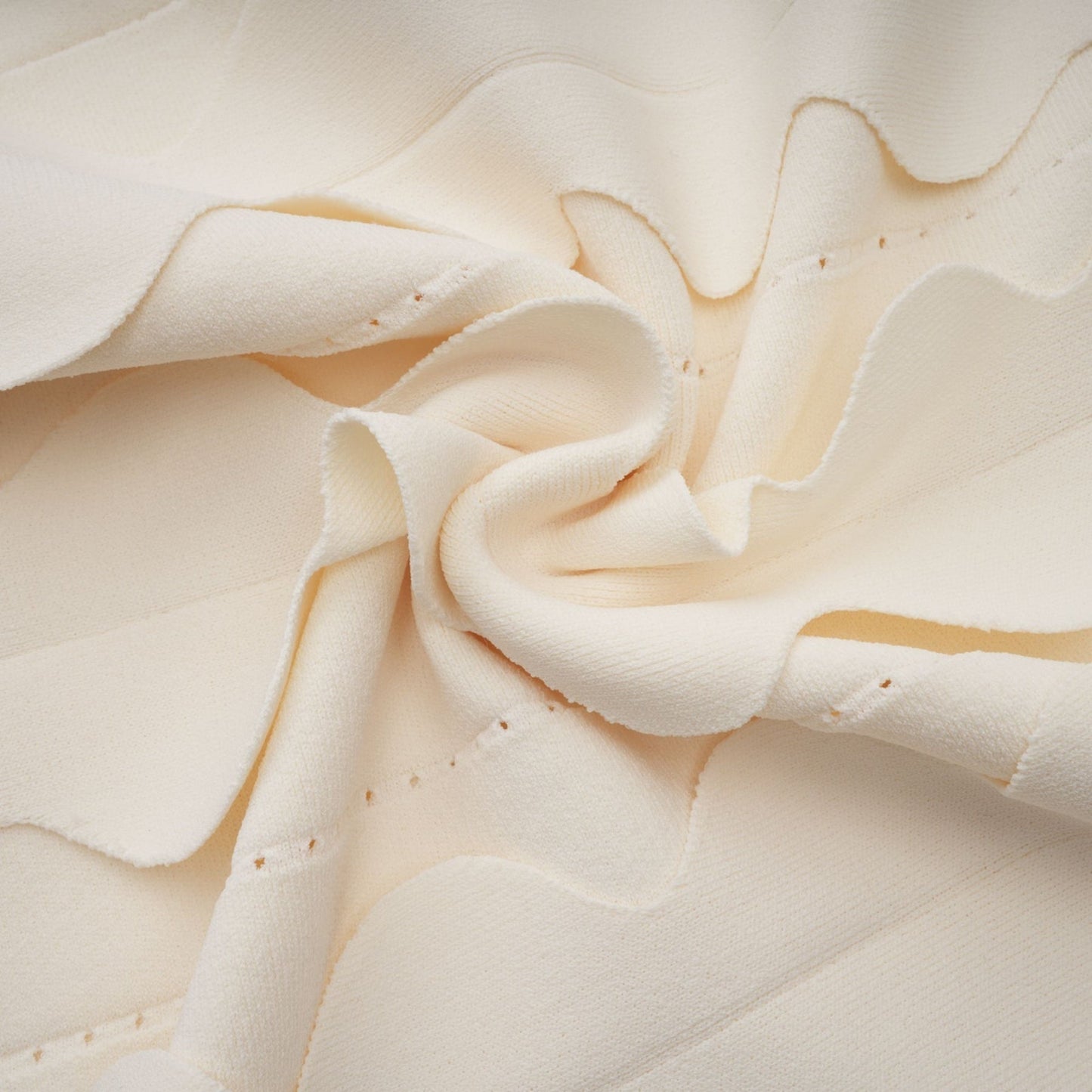 A sleeveless white mini dress with wavy details called Axelle