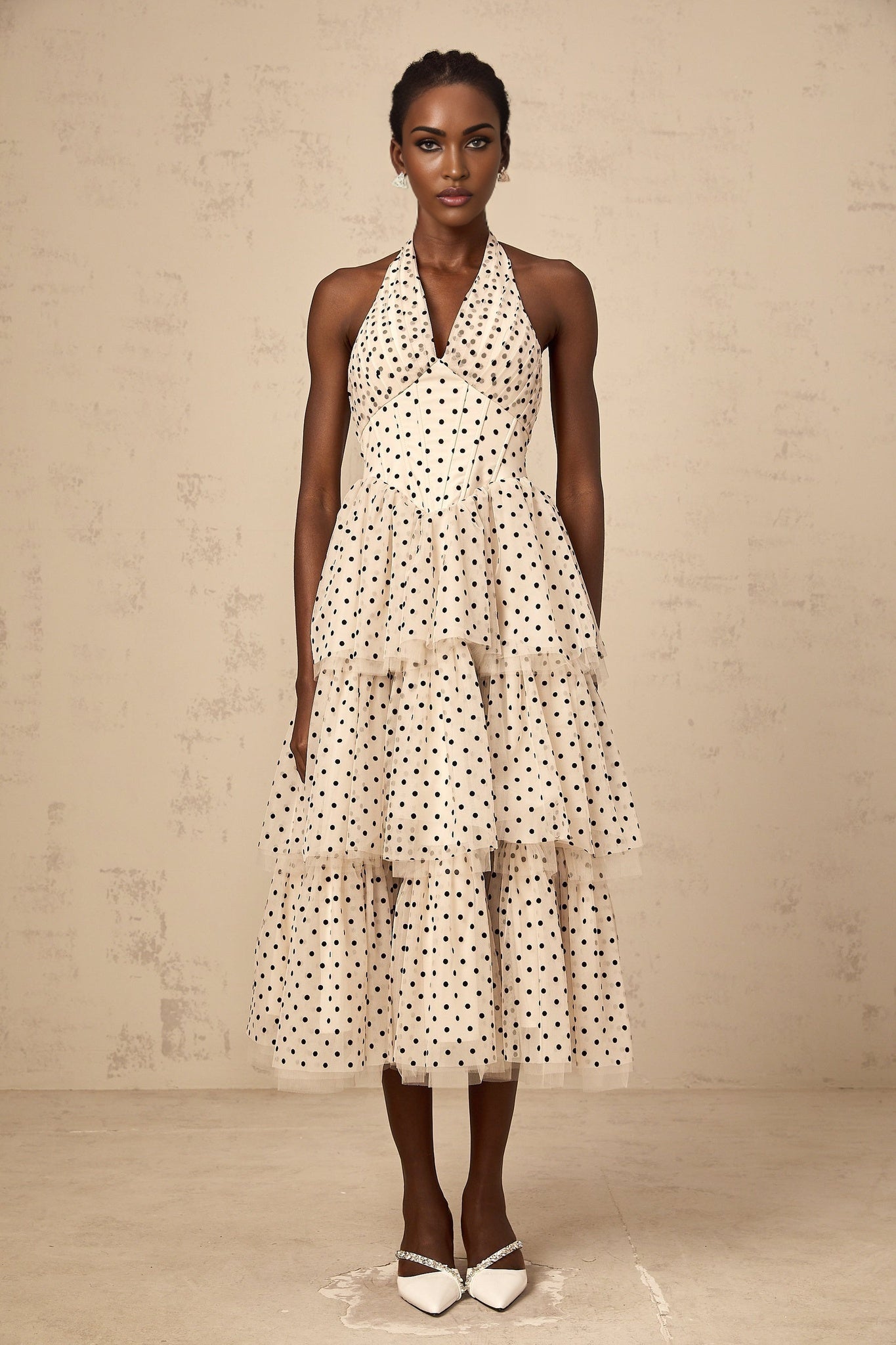 A tiered midi dress in ivory color with polka dot pattern named Philae featuring multiple layers in the skirt