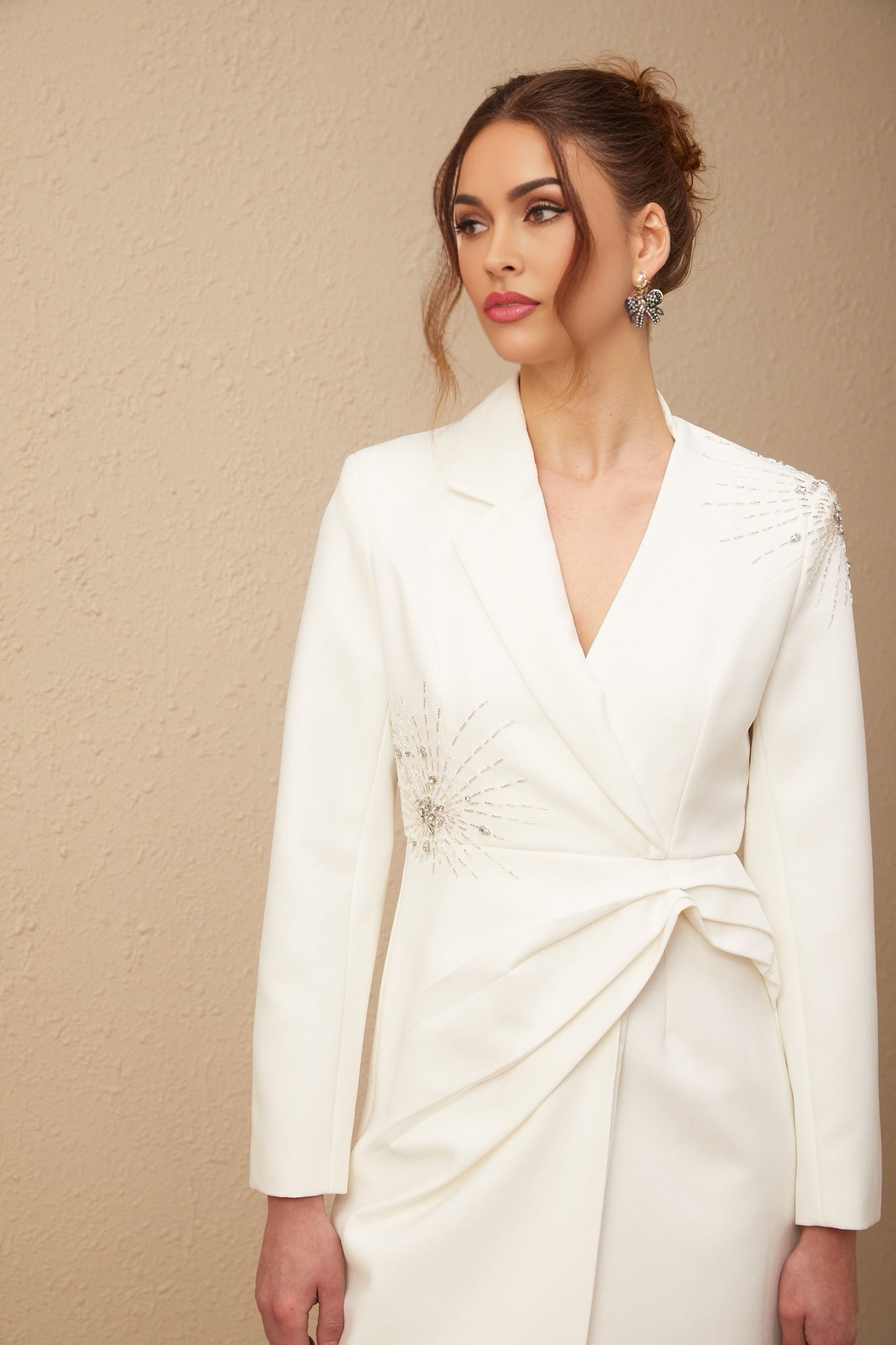 A white asymmetric blazer dress with embellishments named Mireille featuring a tailored silhouette and decorative details