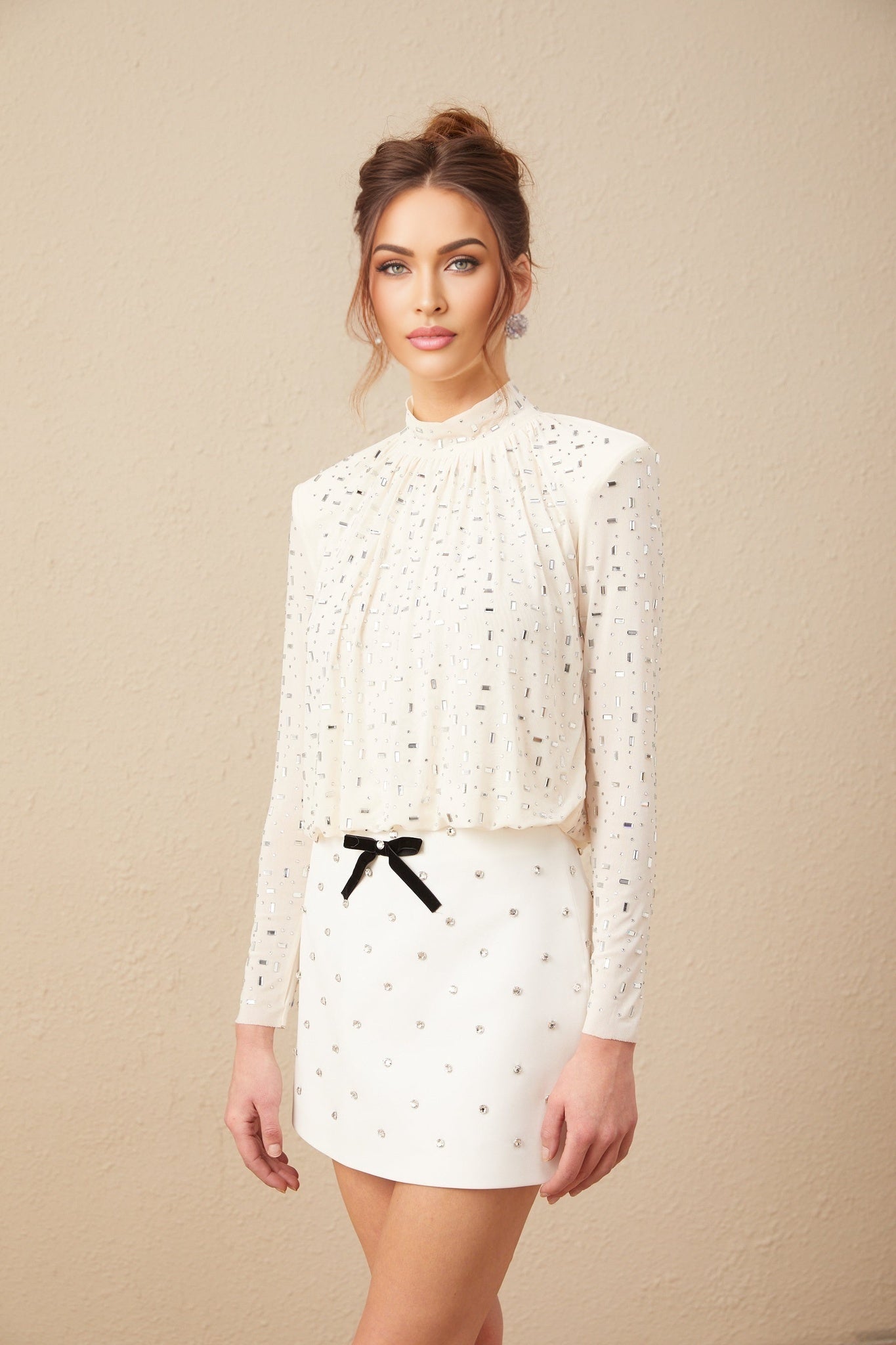 A white blouse with crystal embellishments suitable for Valentines Day featuring a feminine design and sparkly accents