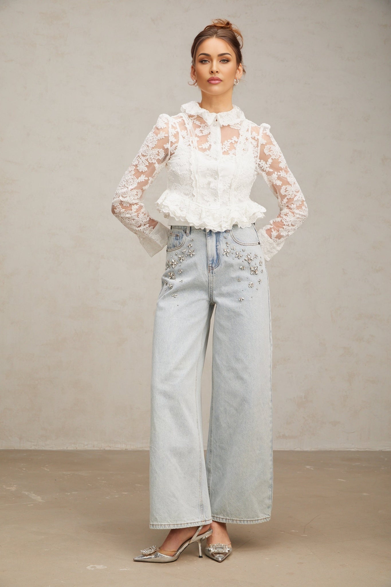 A white blouse with delicate floral embroidery and lace details featuring a feminine design and intricate patterns