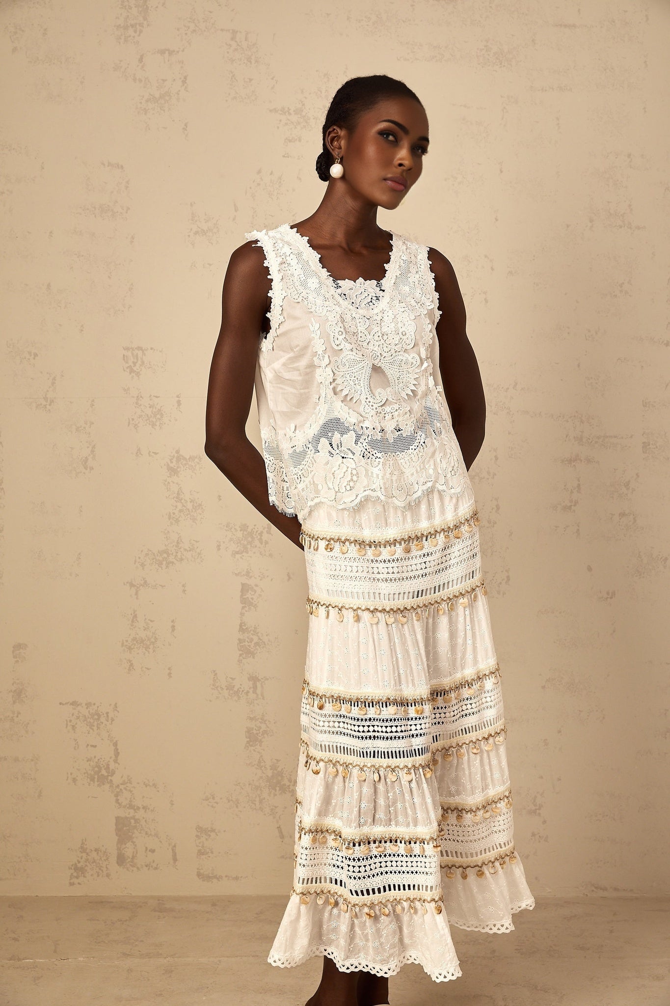 A white bohemian style midi skirt with shirred waistband and flowing fabric