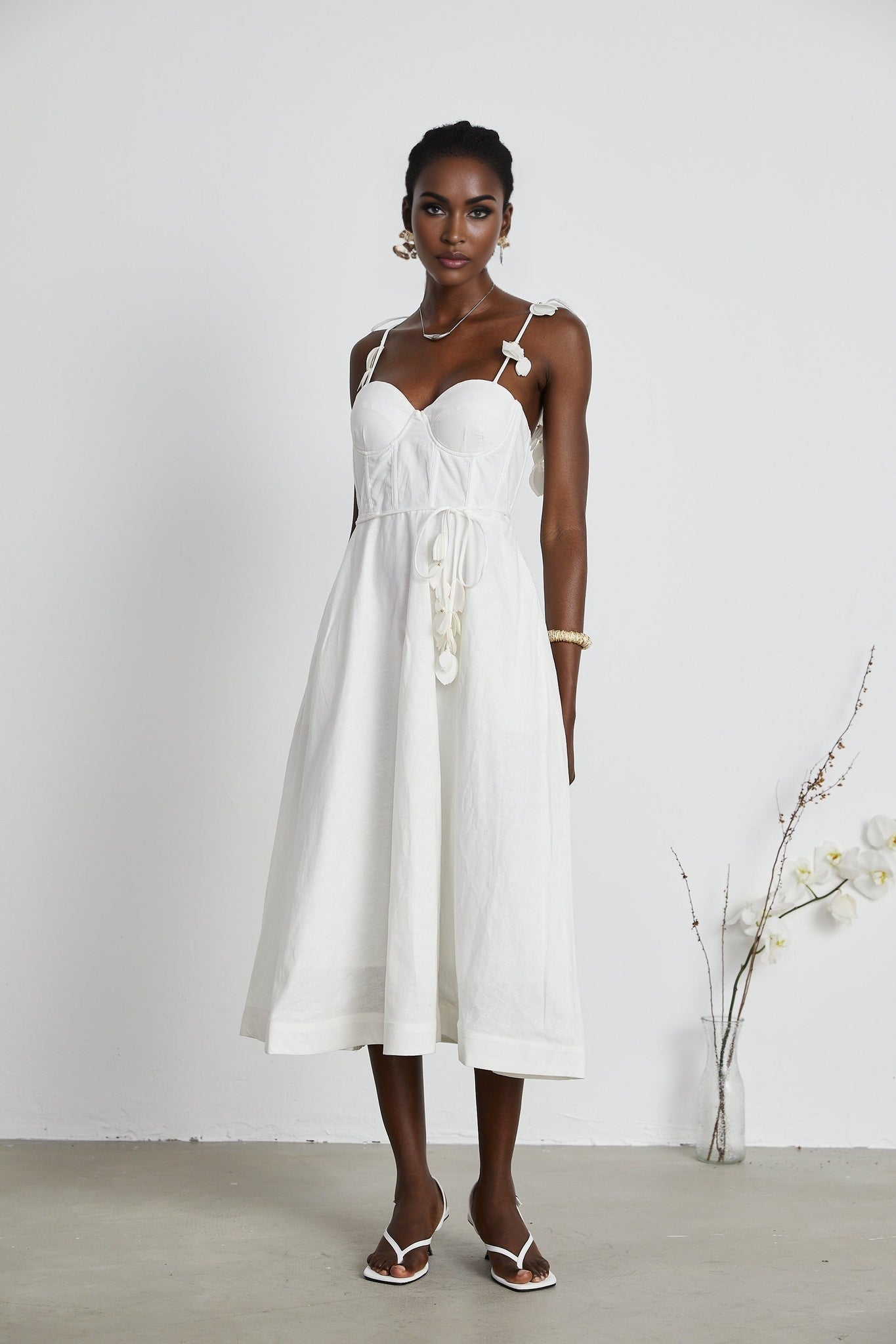 A white corset midi dress with a fitted bodice and flared skirt named Helene