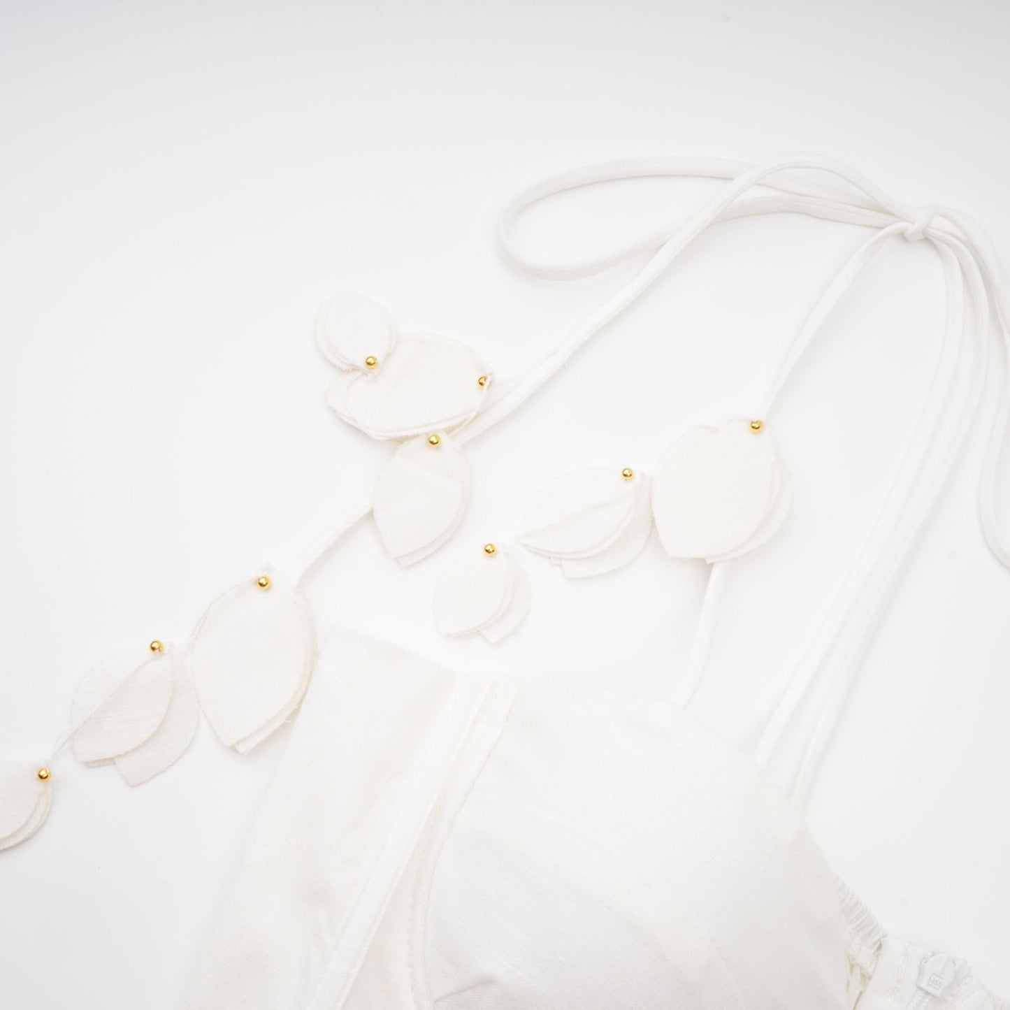 A white corset style midi dress with a fitted bodice and flared skirt on a female model