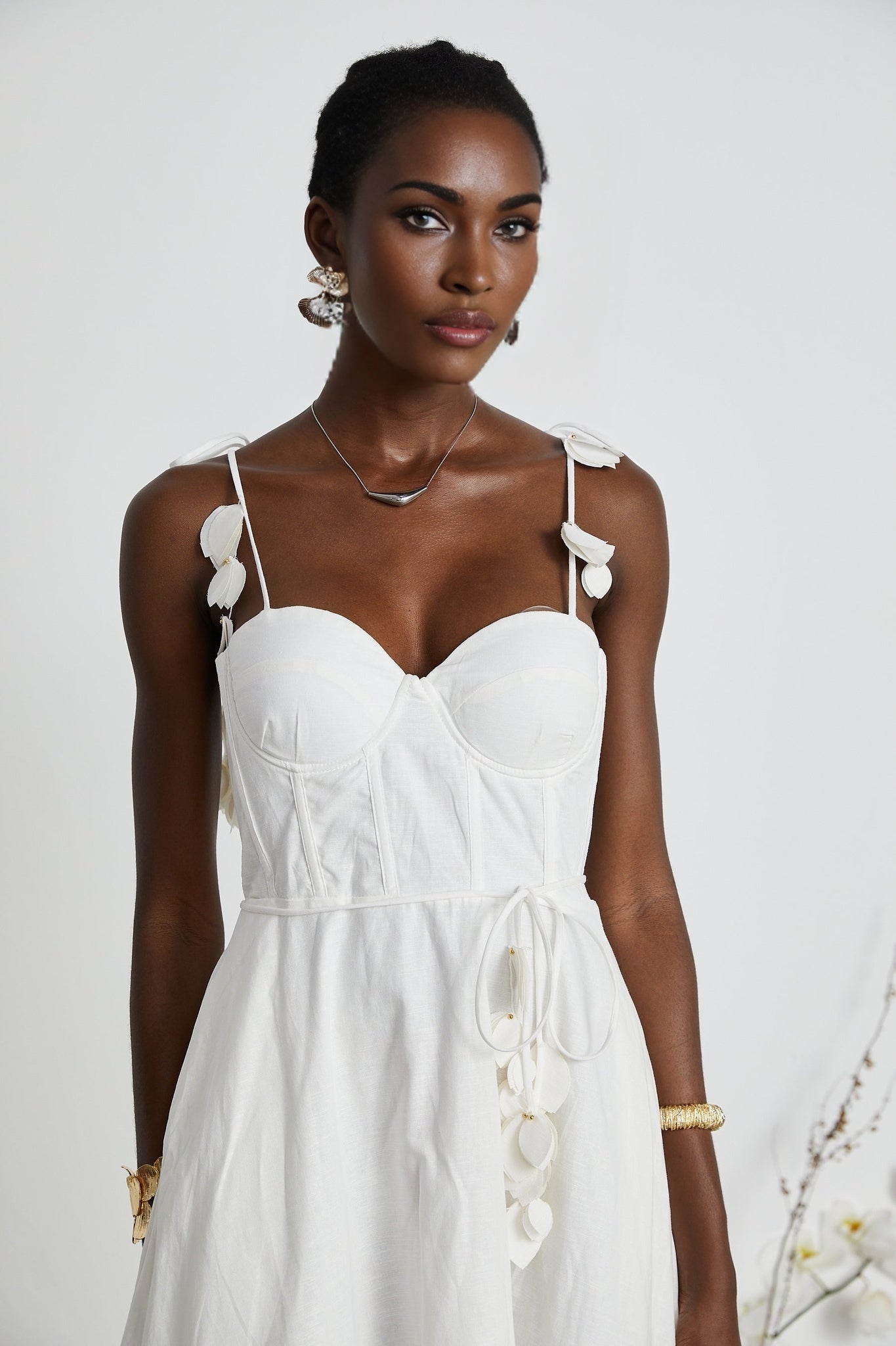A white corset style midi dress with a fitted bodice and flared skirt
