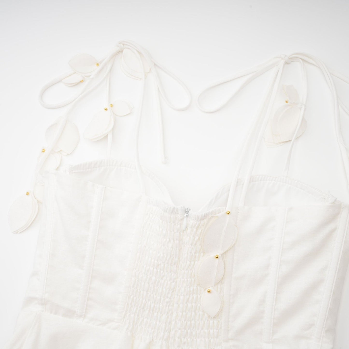 A white corset style midi dress with a fitted bodice and flared skirt