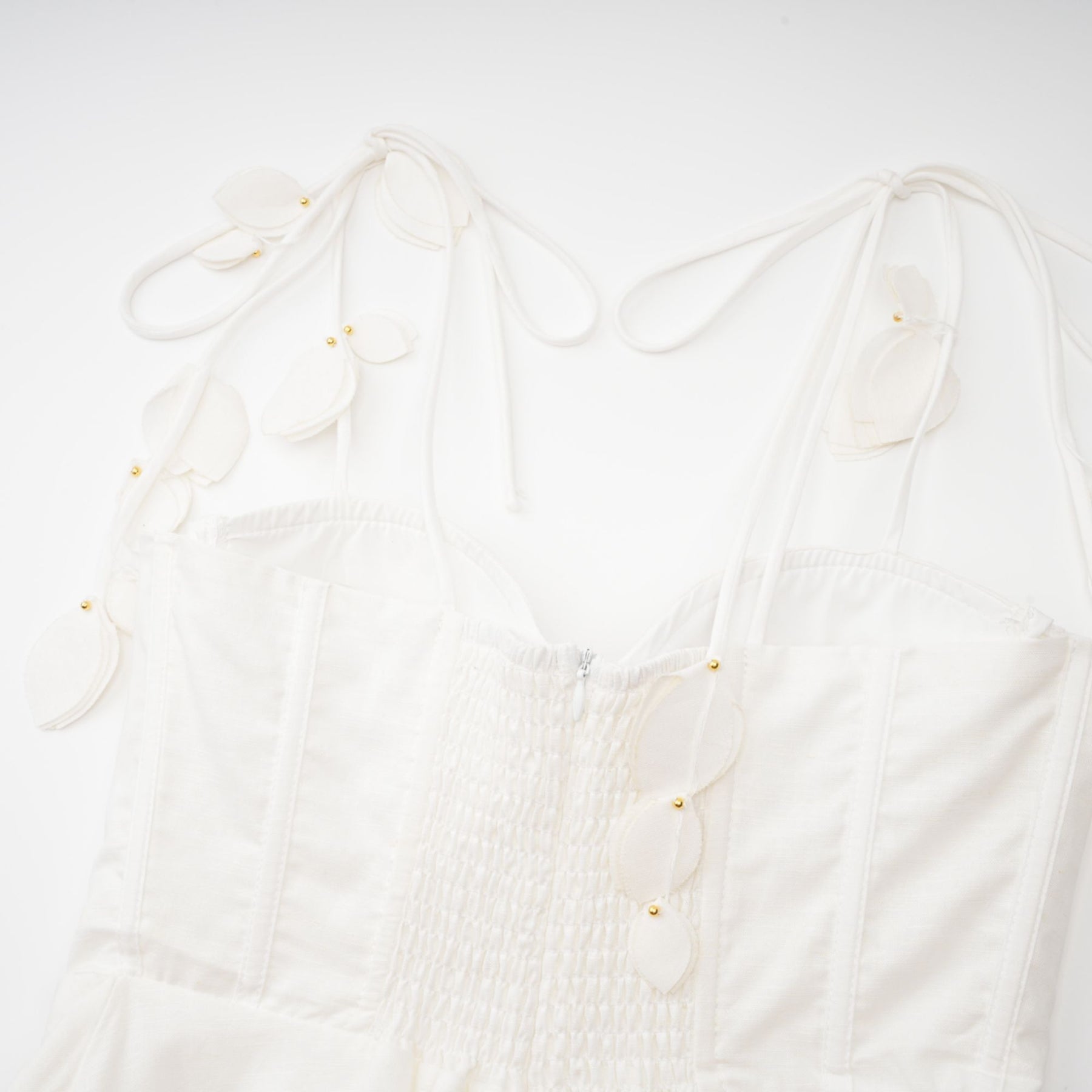 A white corset style midi dress with a fitted bodice and flared skirt