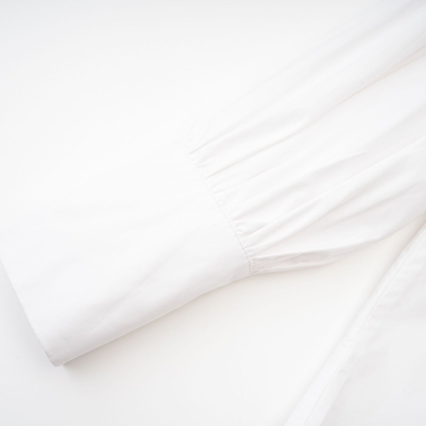 A white cotton buttonup shirt with long sleeves and a tie front detail named Solene