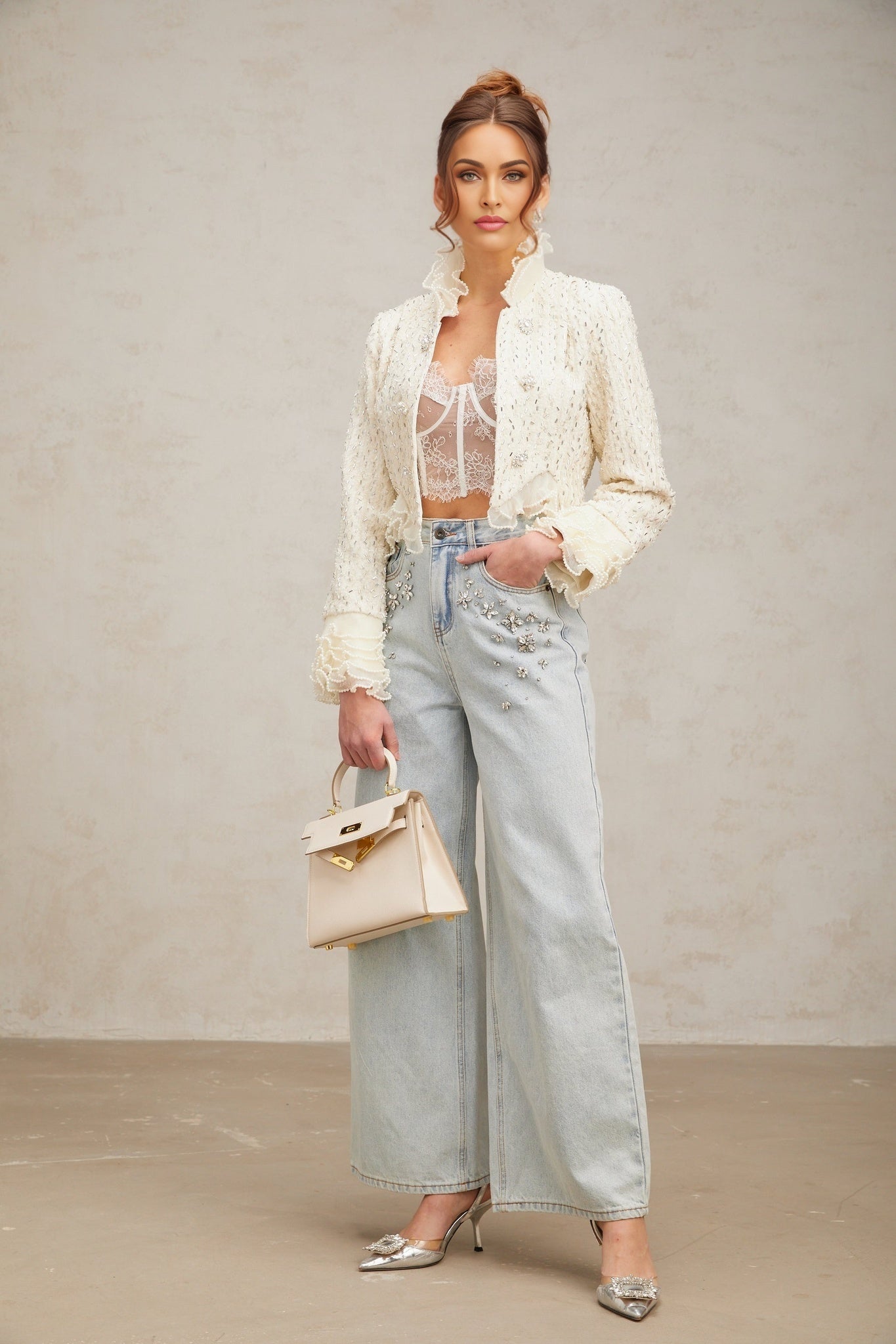 A white cropped jacket with beaded details and ruffle trim named Blanche