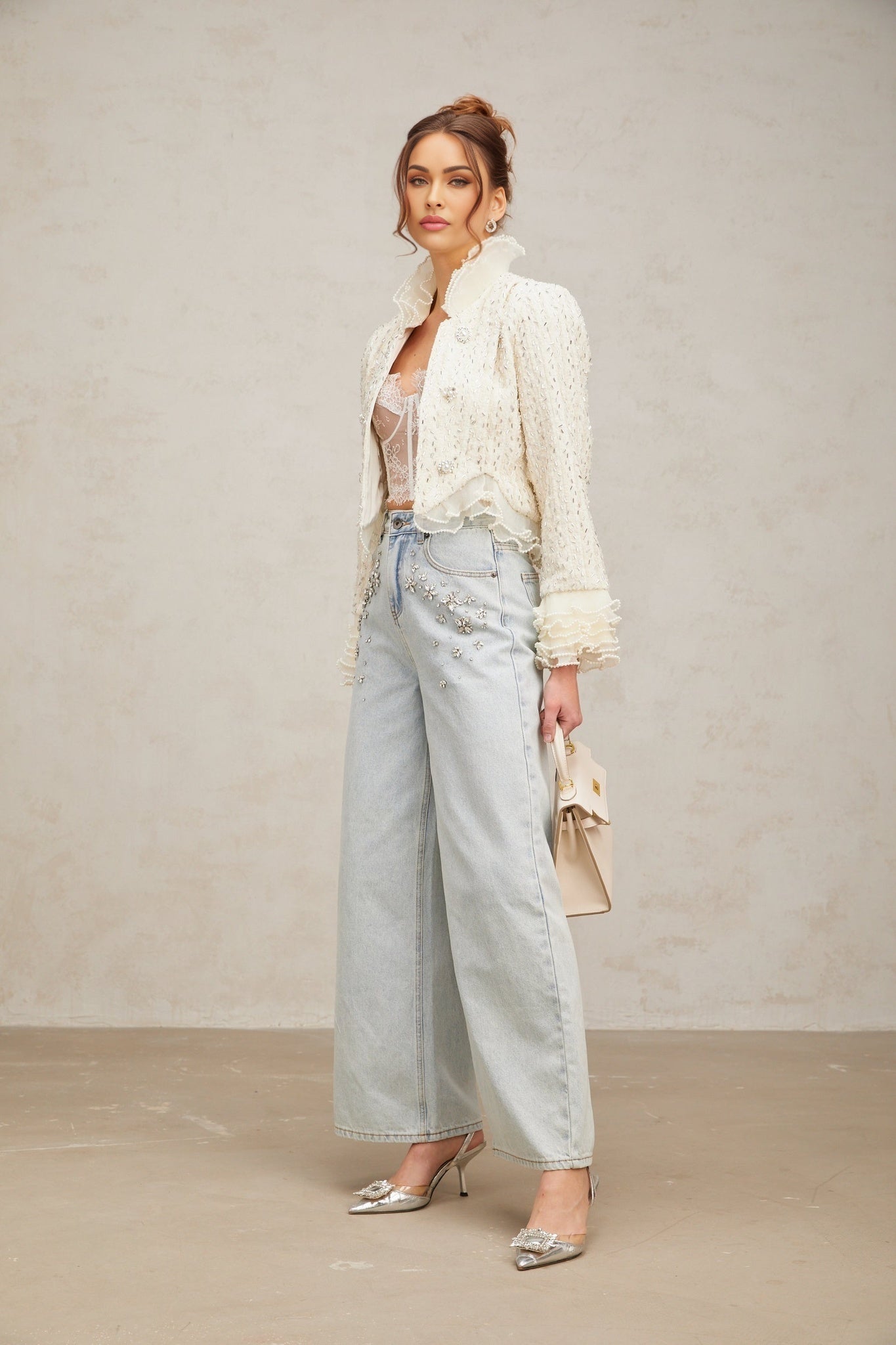 A white cropped jacket with beaded embellishments and ruffle details named Blanche