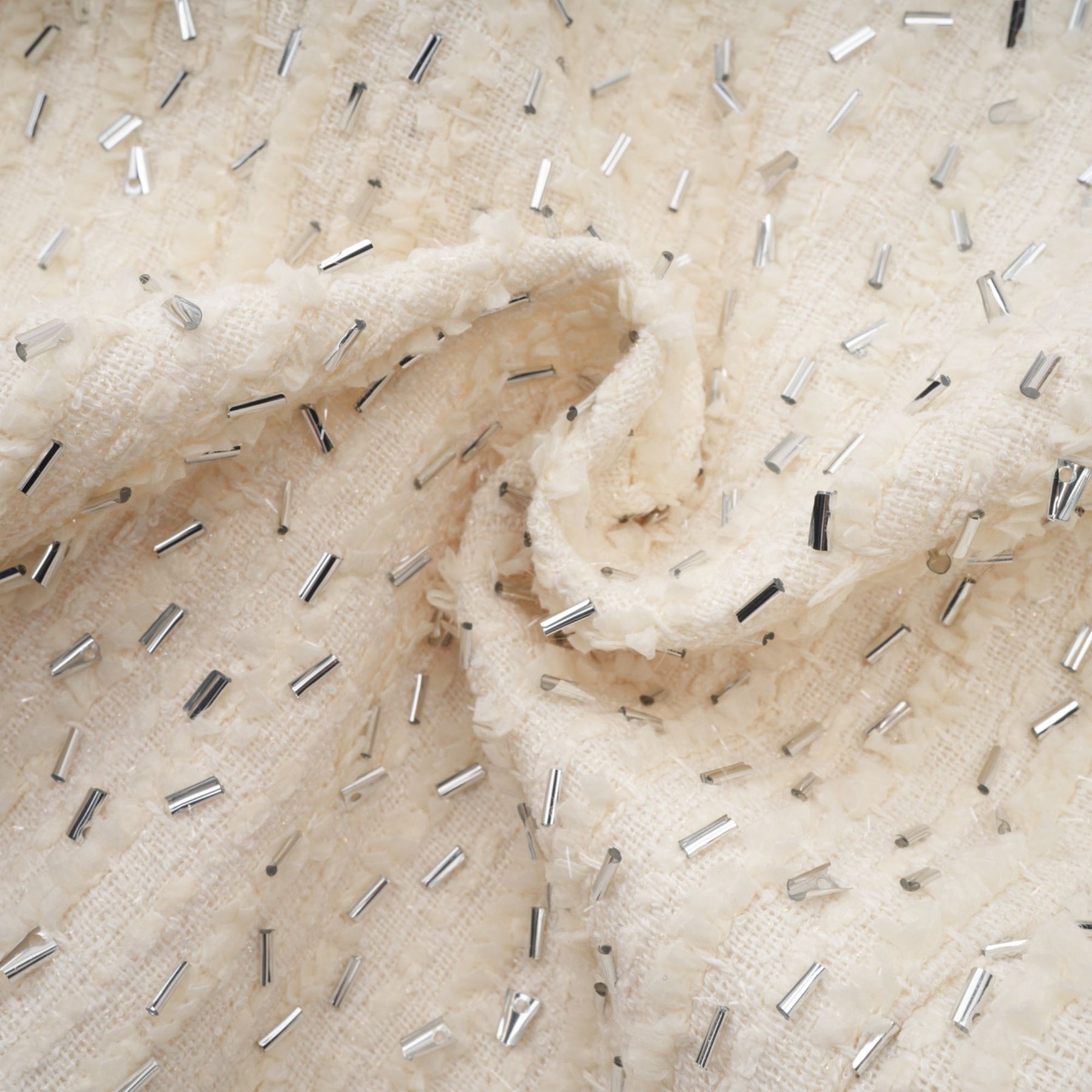 A white cropped jacket with beaded embellishments and ruffled details named Blanche