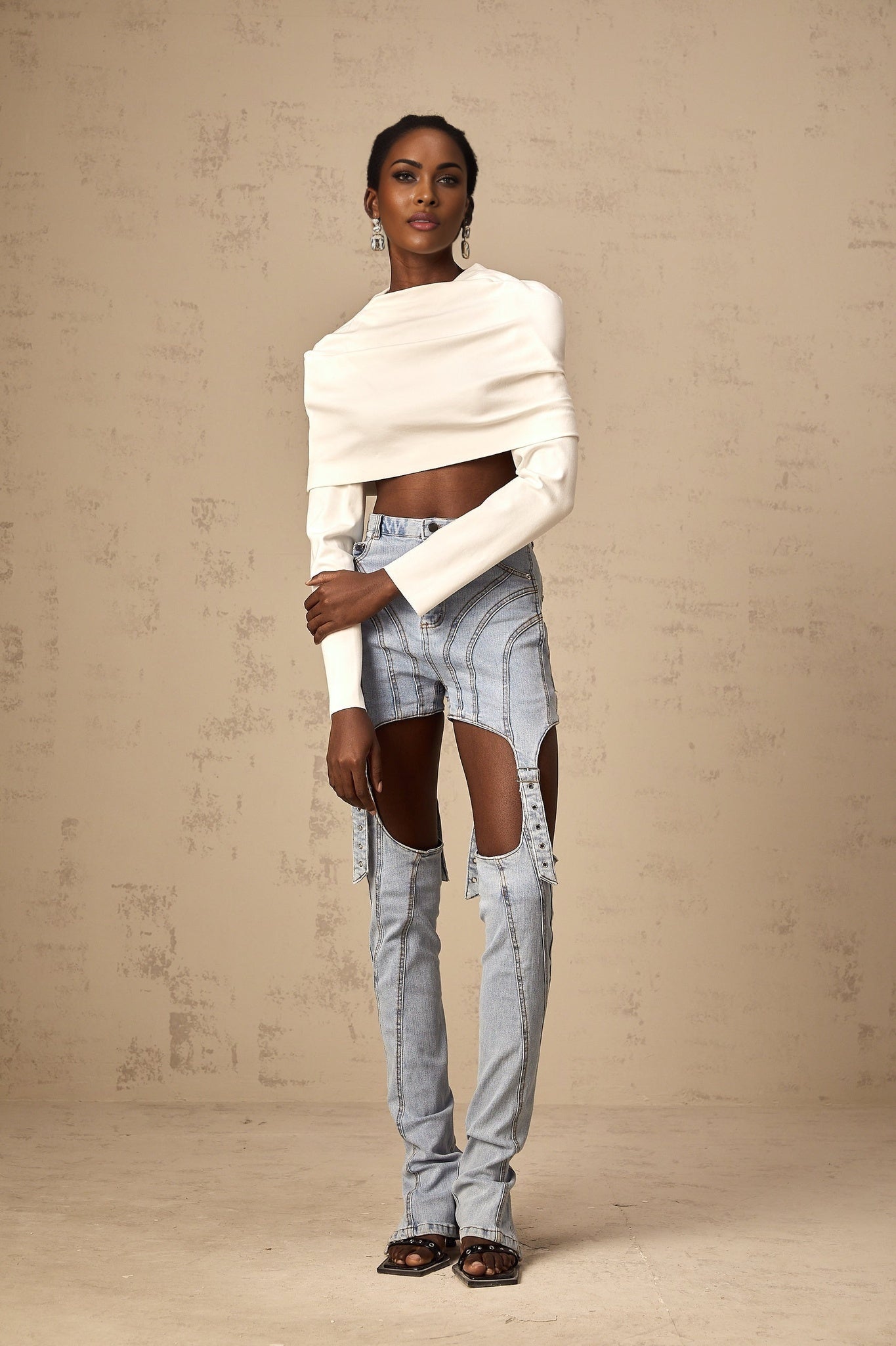 A white cropped top with ruched detailing named Hanna worn by a model against a plain background