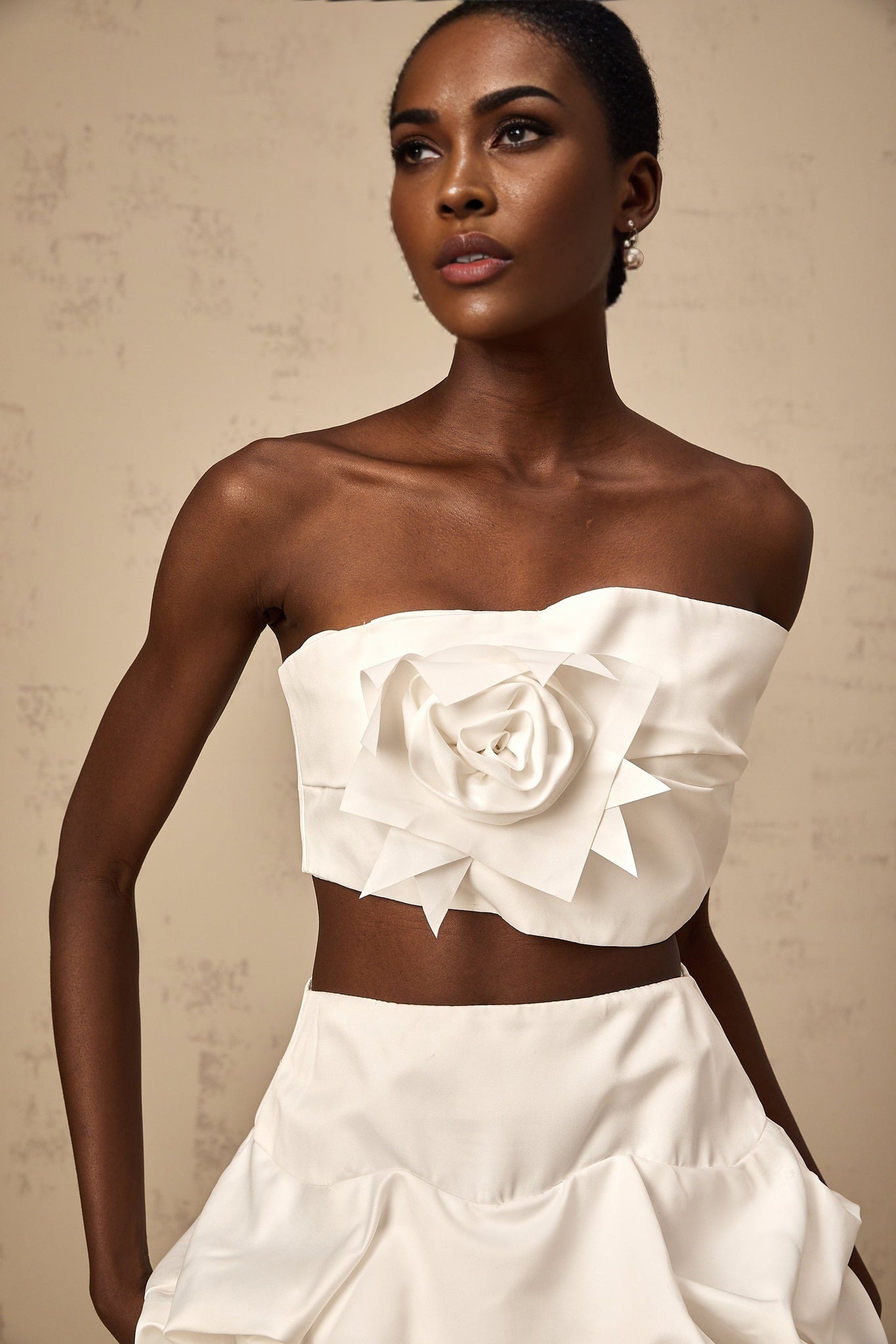 A white floral printed two piece outfit featuring a pleated top and matching skirt from Honorine