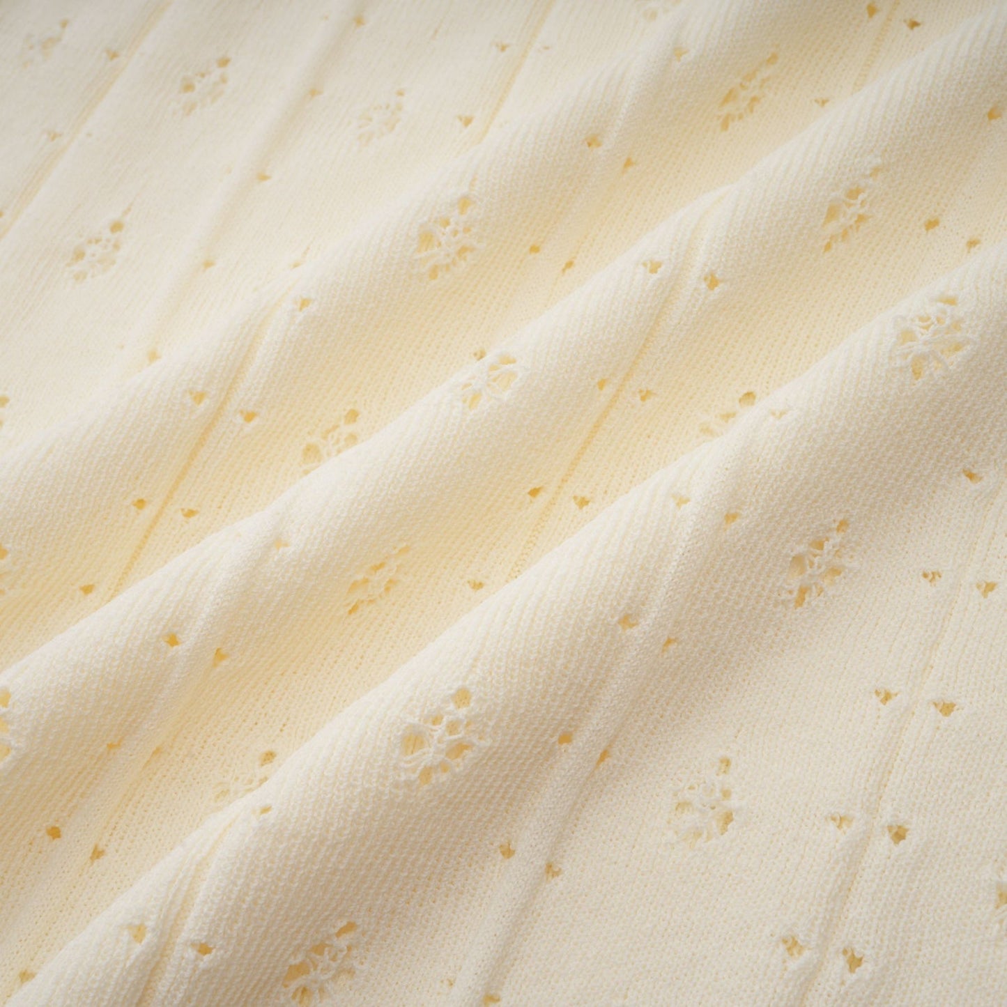 A white knitted maxi dress with faux pearl embellishments