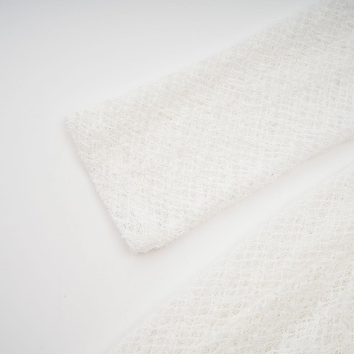 A white lace maxi dress with a wavy pattern featuring the Athena design worn by a model standing against a plain background