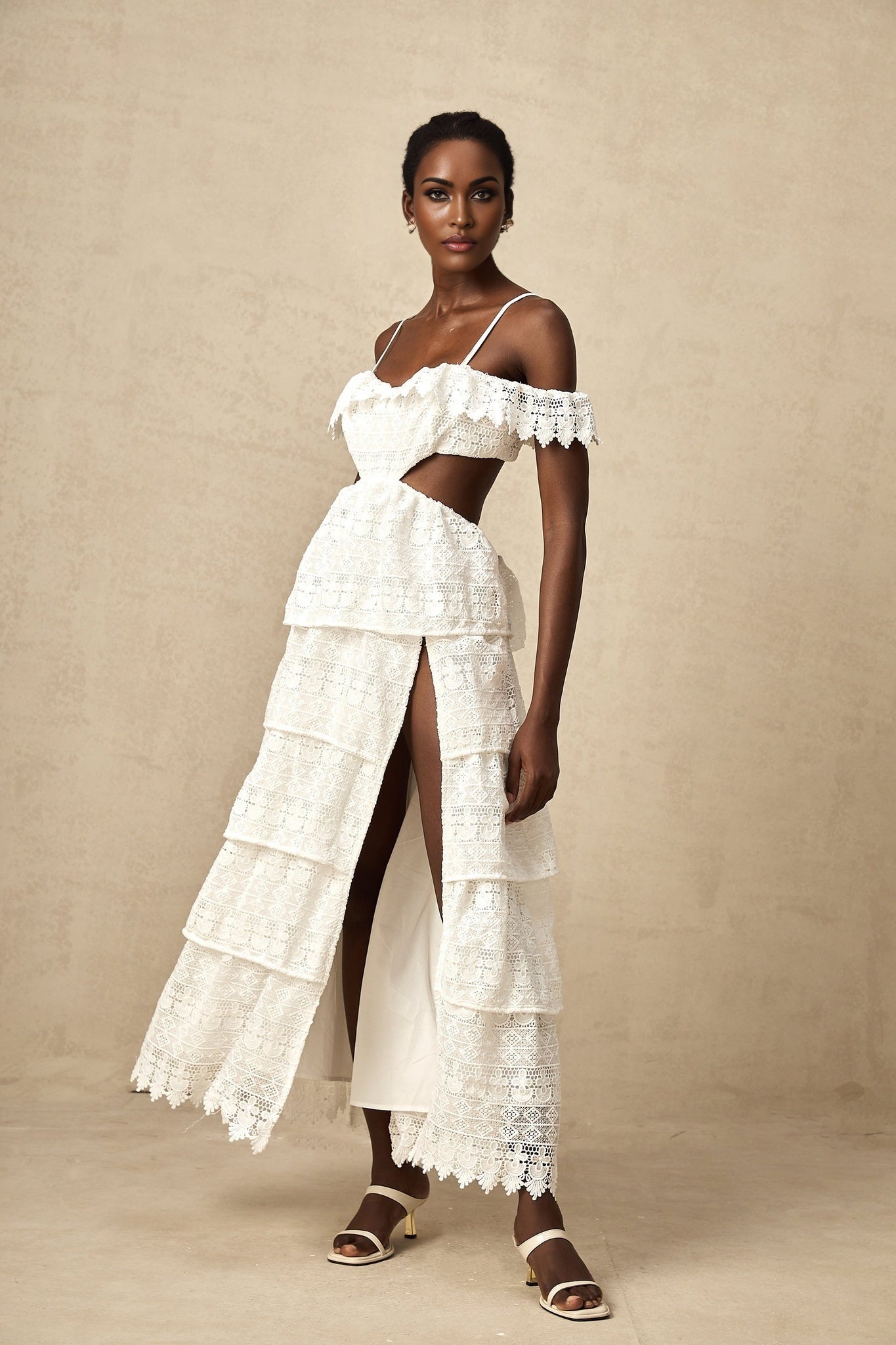 A white lace midi dress with openwork detailing named Genevieve featuring a delicate feminine design and intricate lace patterns throughout the garment