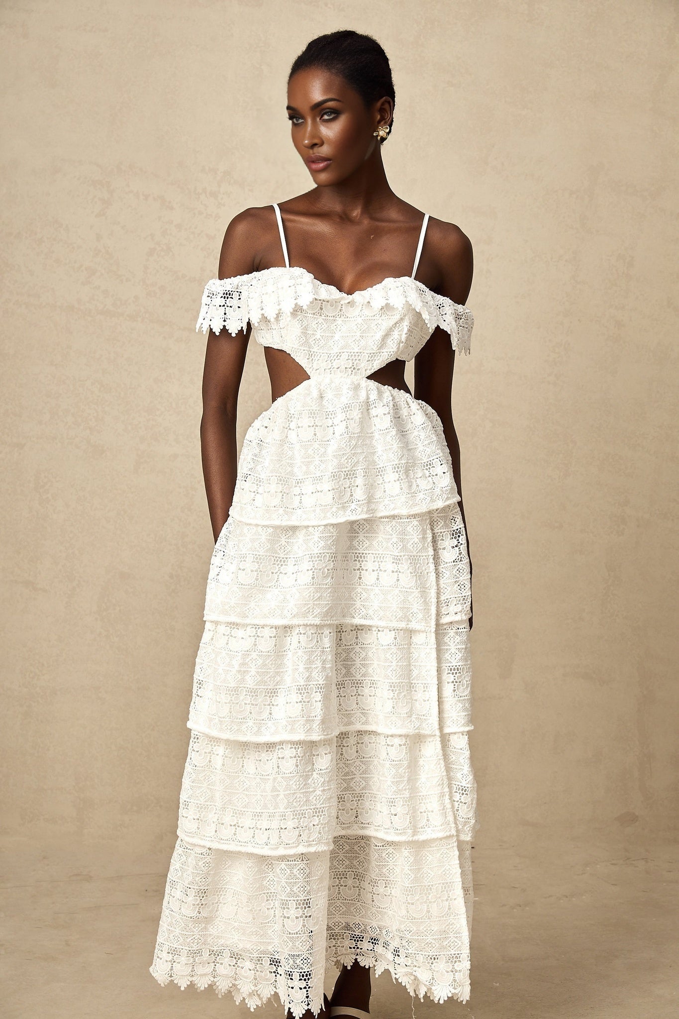 A white lace midi dress with openwork detailing named Genevieve featuring a delicate feminine design with a flowy silhouette and intricate lace patterns