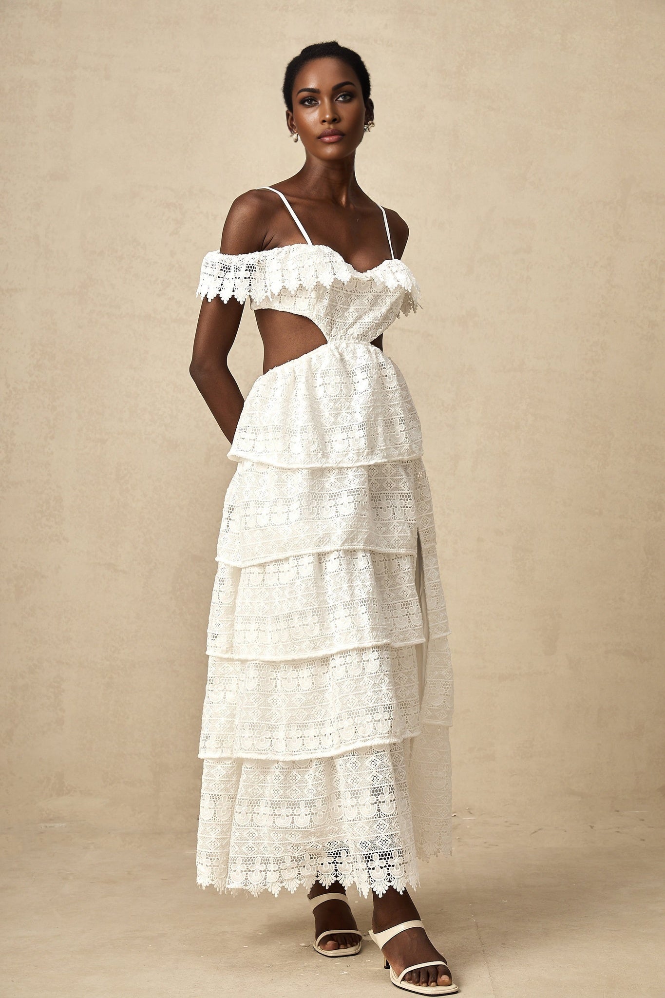 A white lace midi dress with openwork detailing named Genevieve featuring a delicate pattern and elegant design