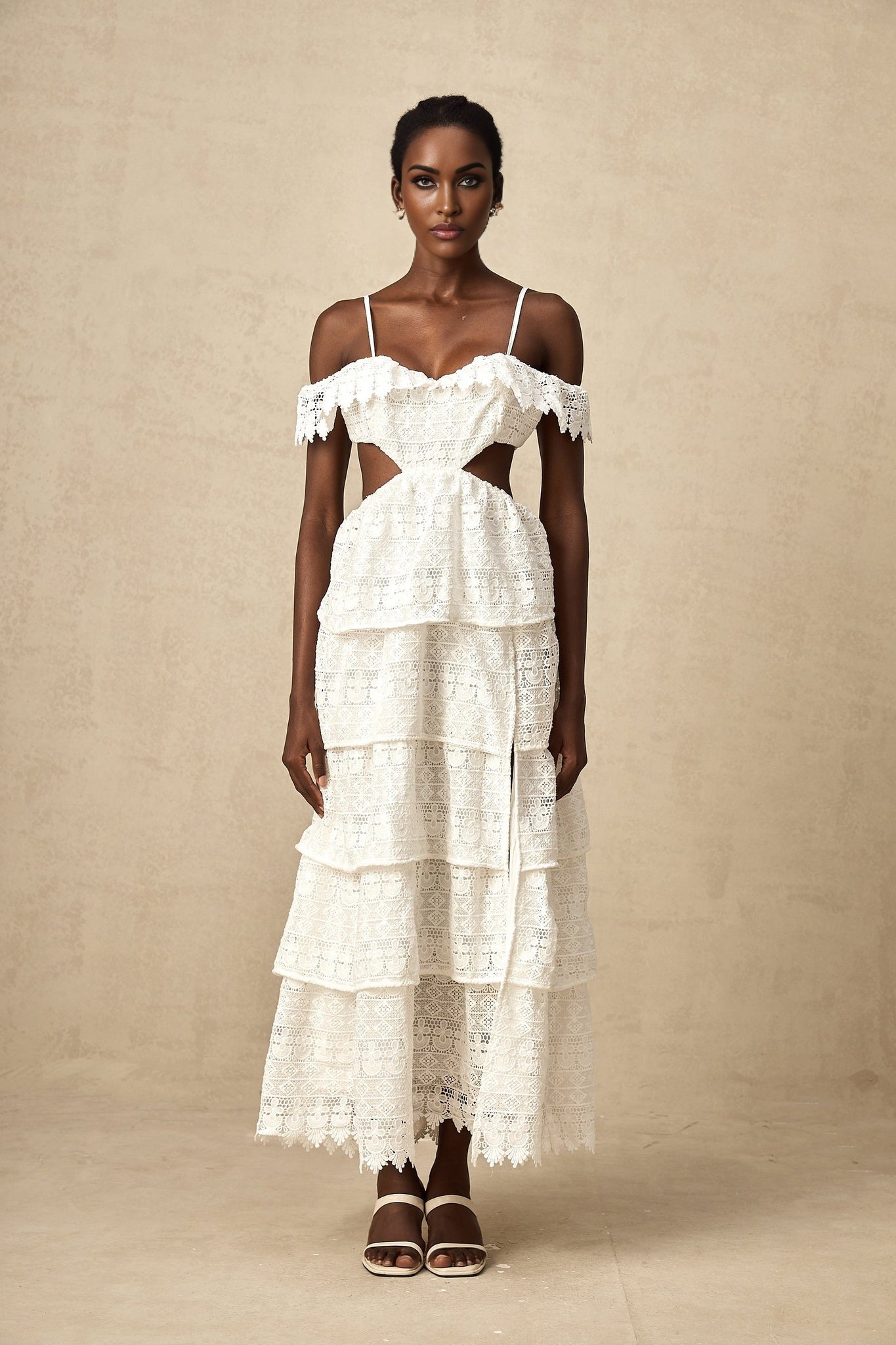 A white lace midi dress with openwork details and a delicate floral pattern named Genevieve
