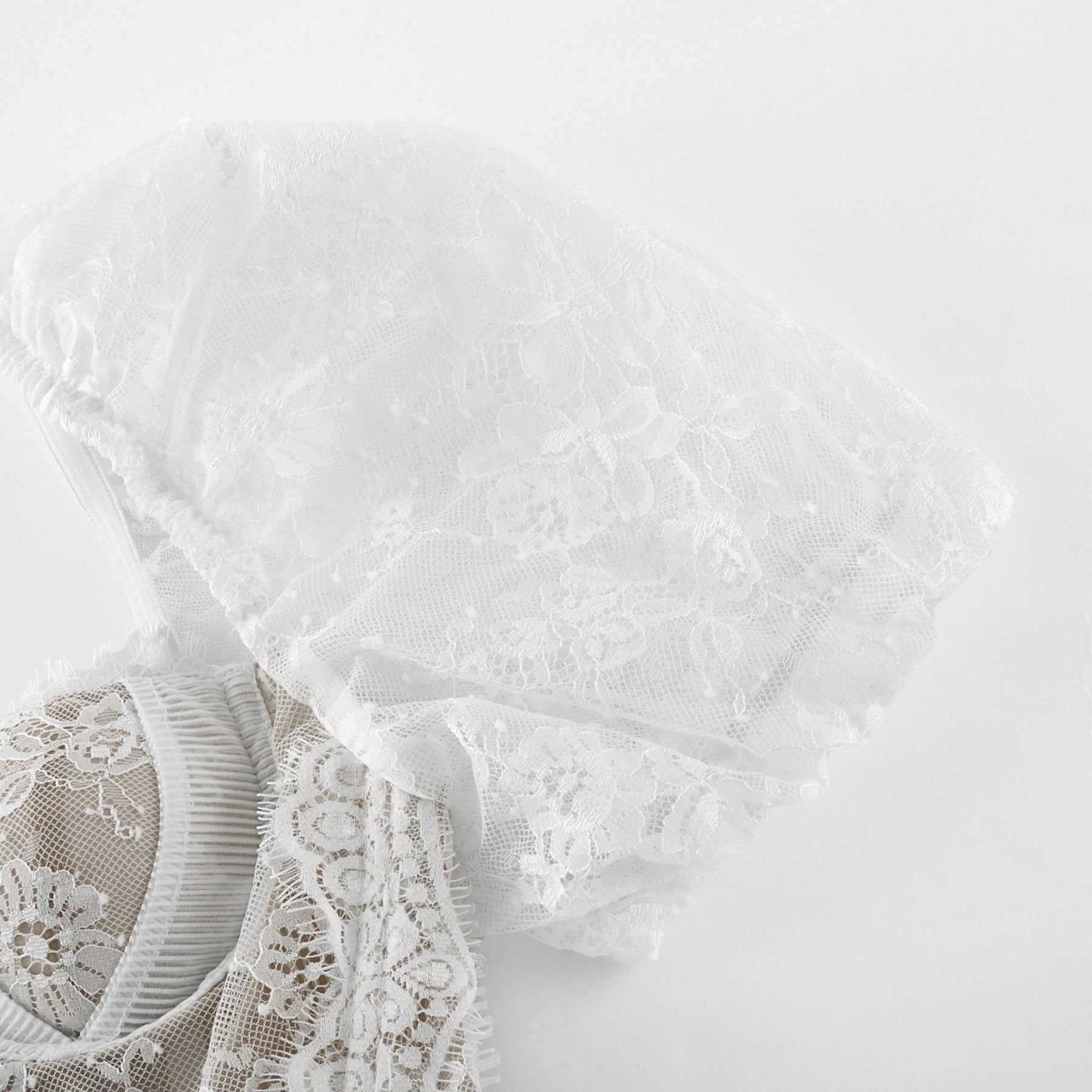 A white lace midi dress with tiered layers by Melisande