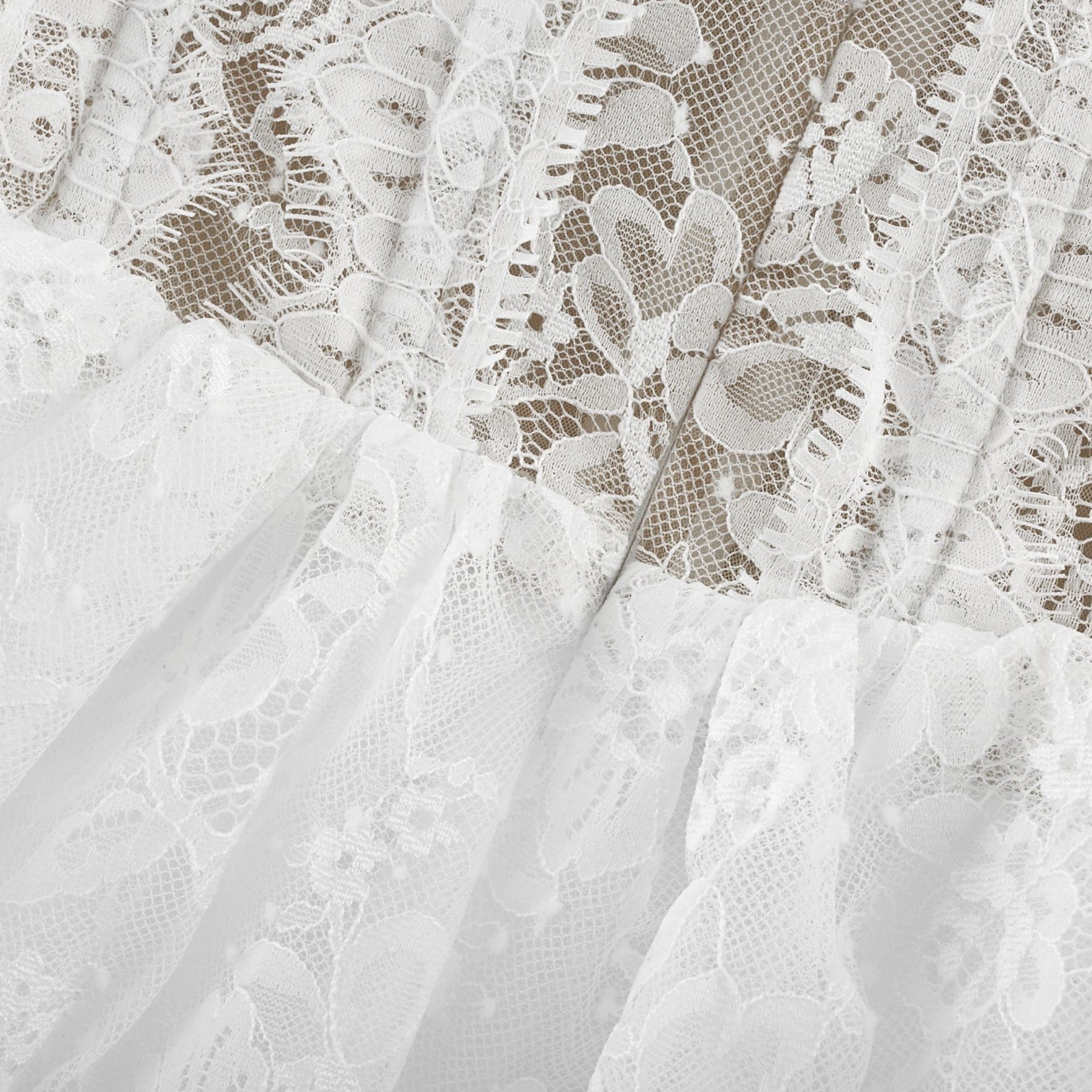 A white lace midi dress with tiered layers from Melisande