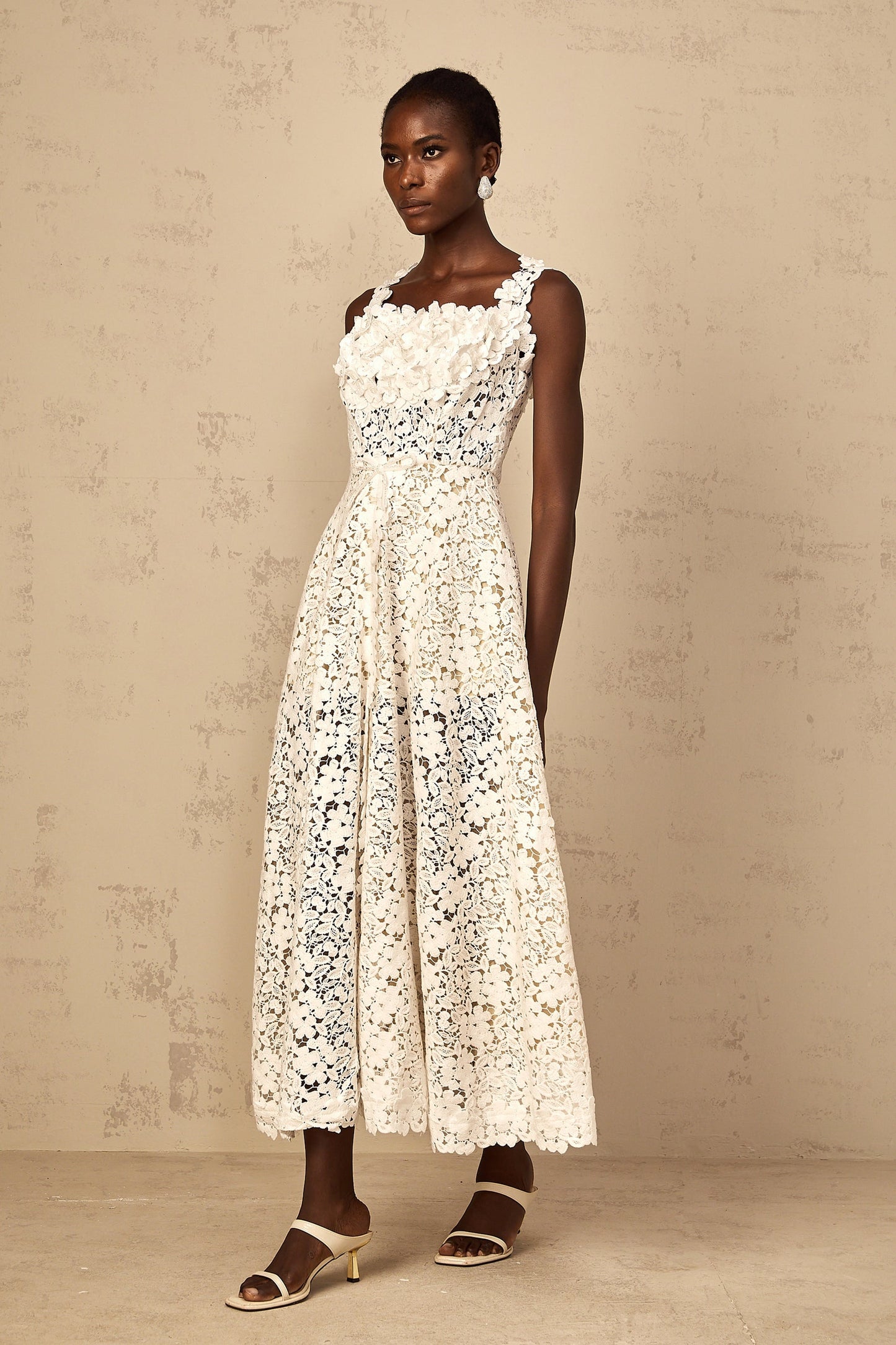A white maxi dress for women featuring shirred detailing and corded lace design with a fulllength silhouette