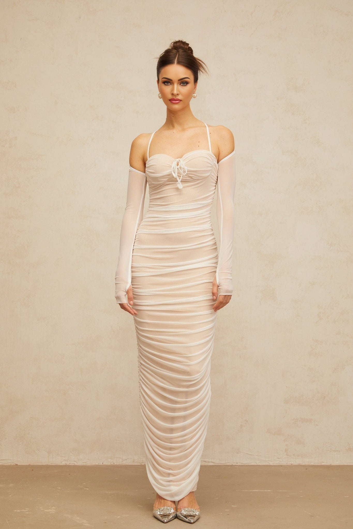 A white maxi dress with a ruched bustier top and flowing tulle skirt
