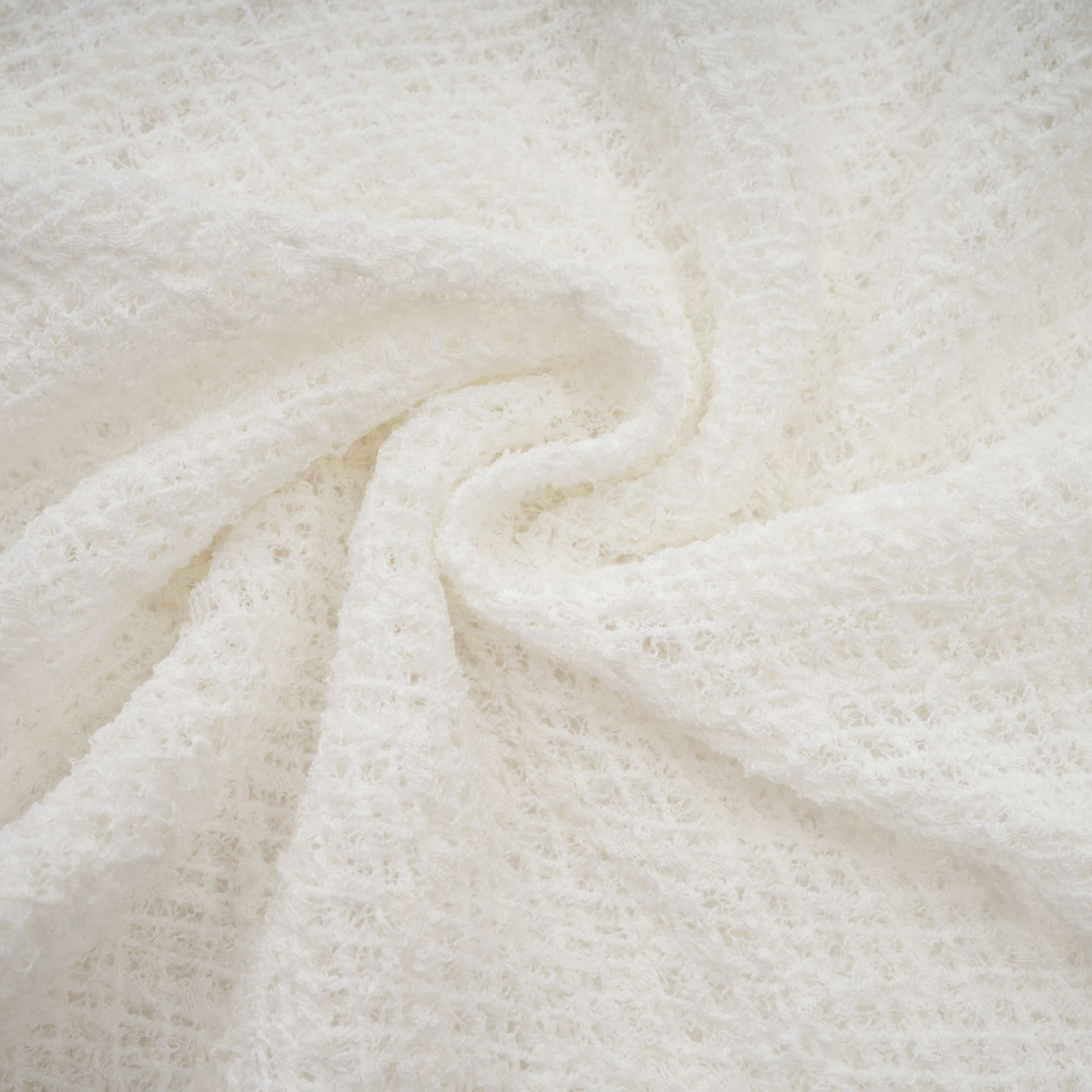 A white maxi dress with a wavy lace pattern featuring a long flowing silhouette and delicate feminine design