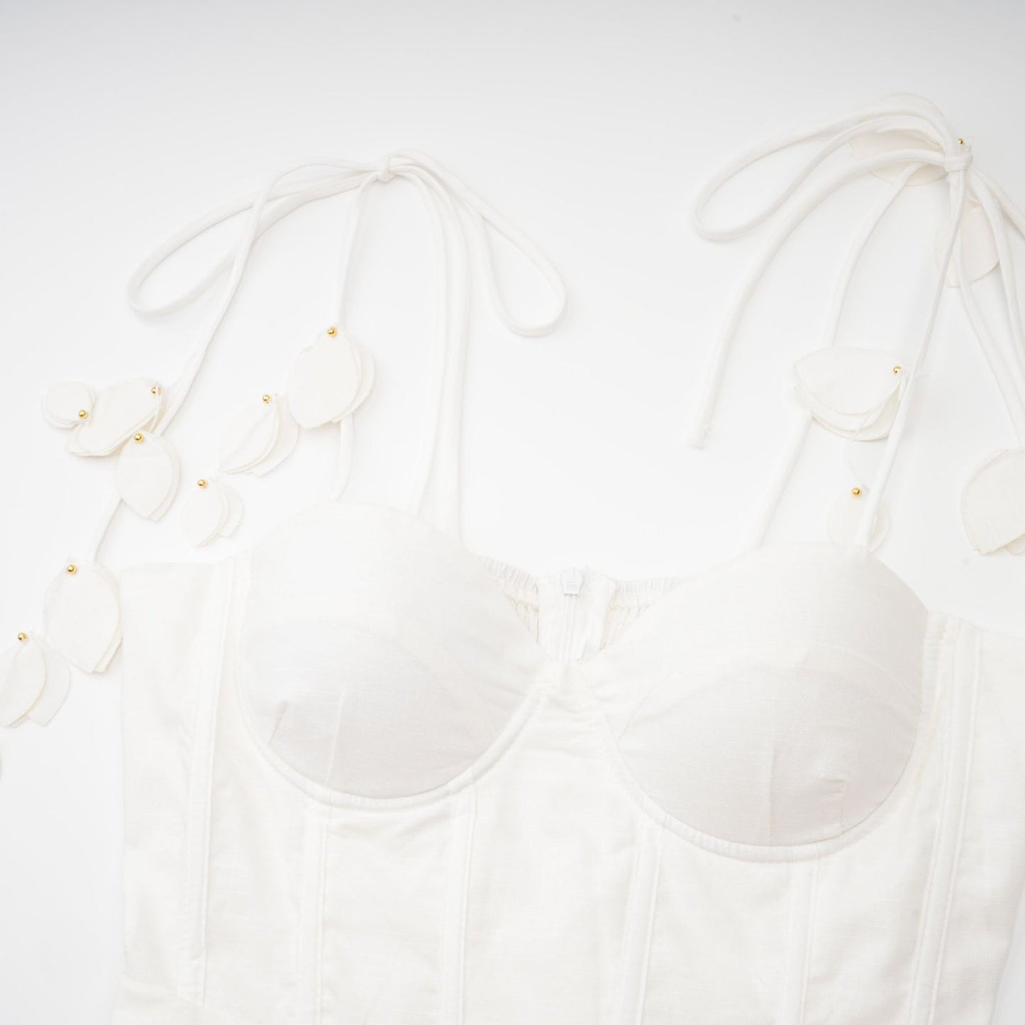 A white midi dress with a corsetstyle bodice featuring a fitted waist and flared skirt