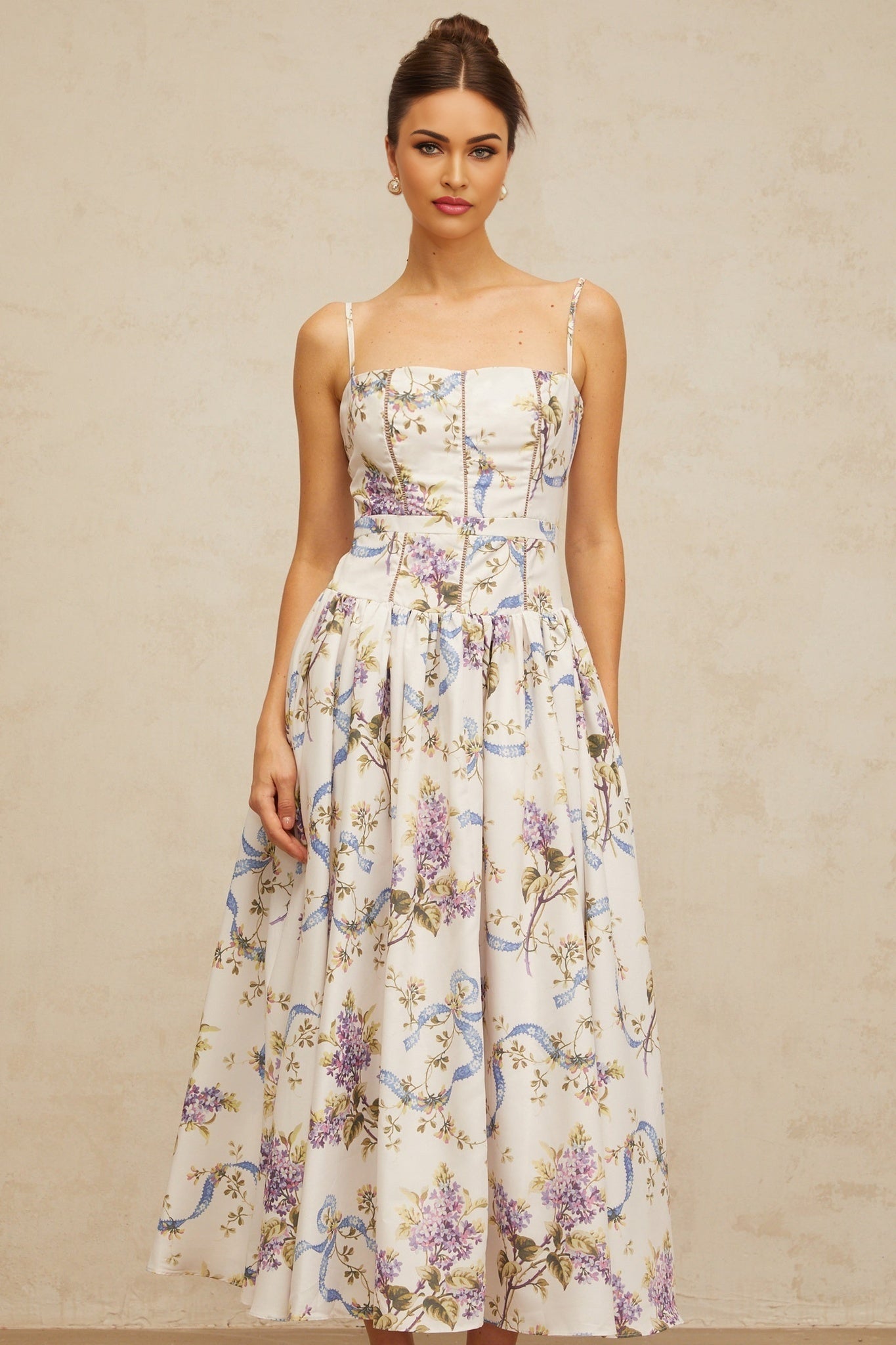 A white midi dress with a floral print pattern featuring a design called Fleur