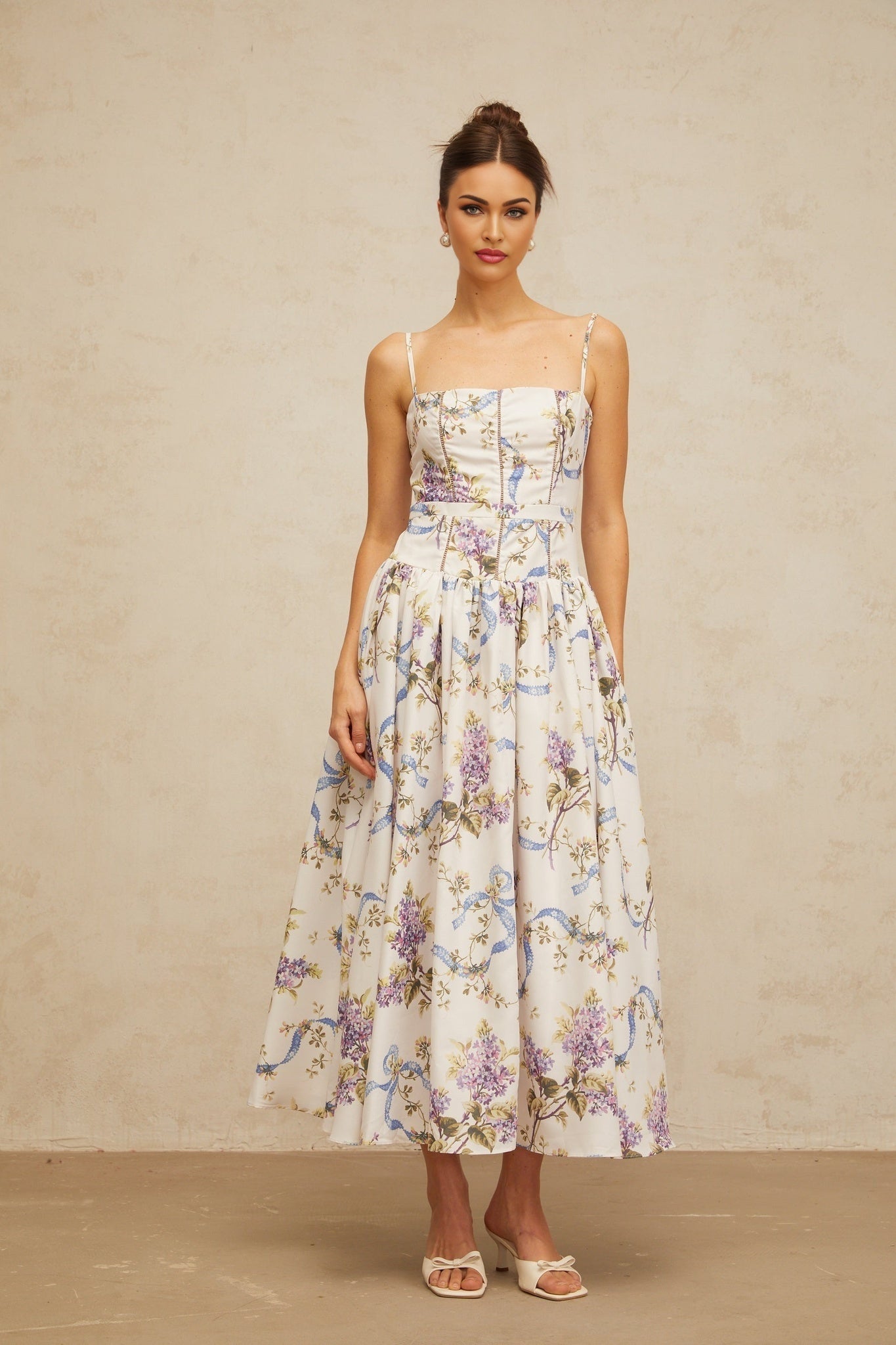 A white midi dress with a floral print pattern featuring a Fleur design