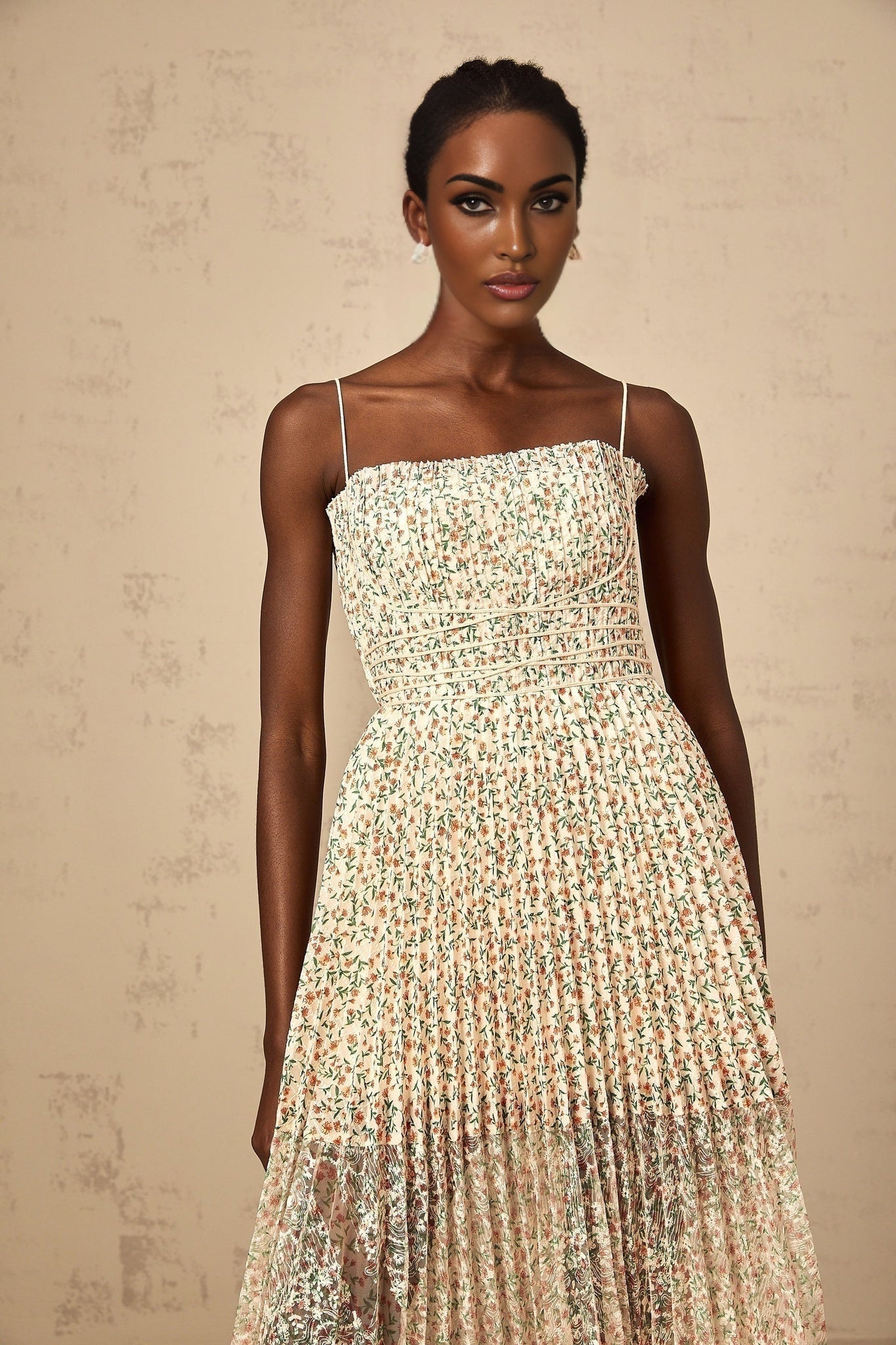 A white midi dress with a floral print pattern featuring pleated details and a Marion design