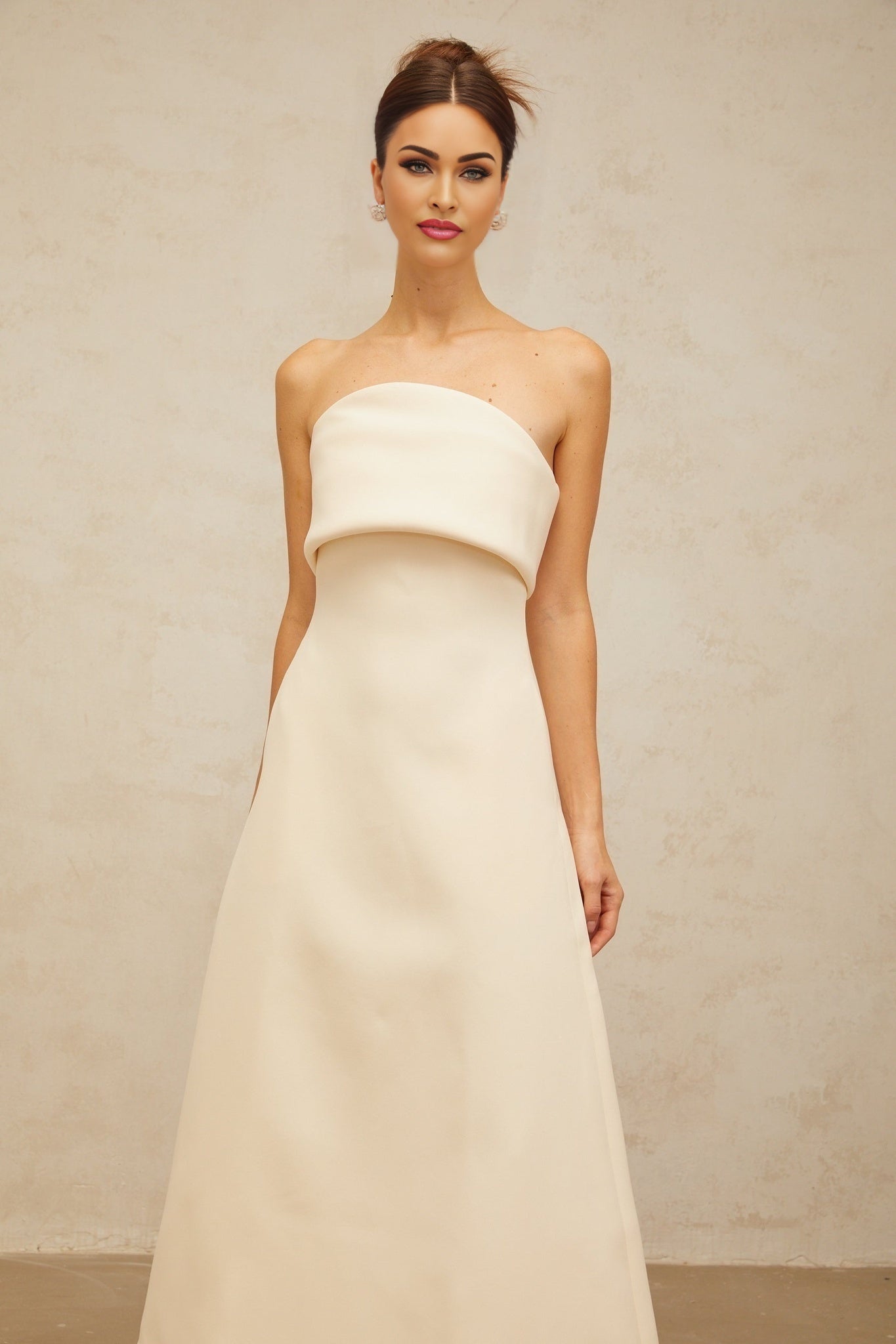 A white midi dress with a folded corset style bodice and a fitted silhouette named Raphaelle