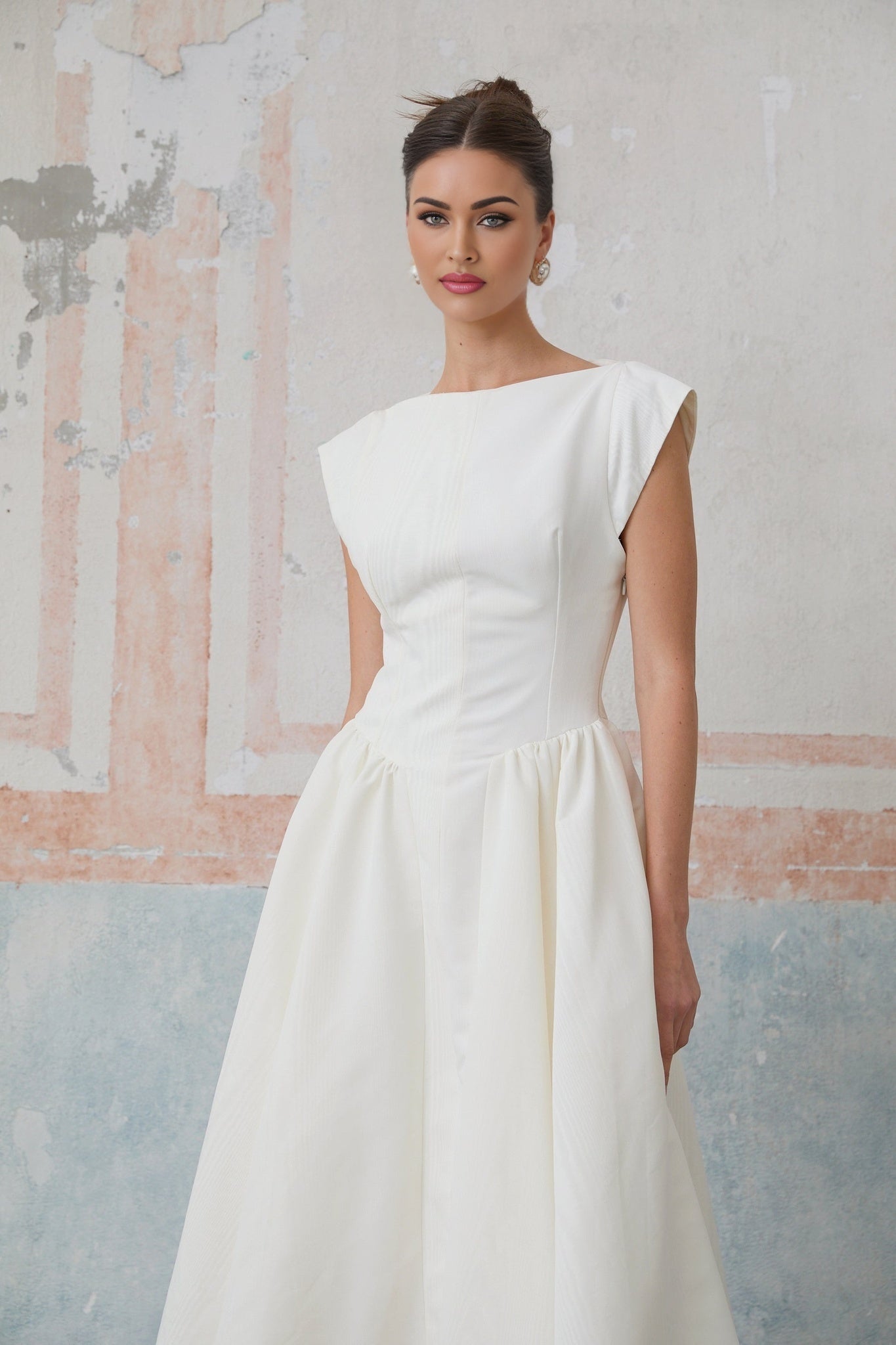 A white midi dress with cap sleeves and an open back named Amandine