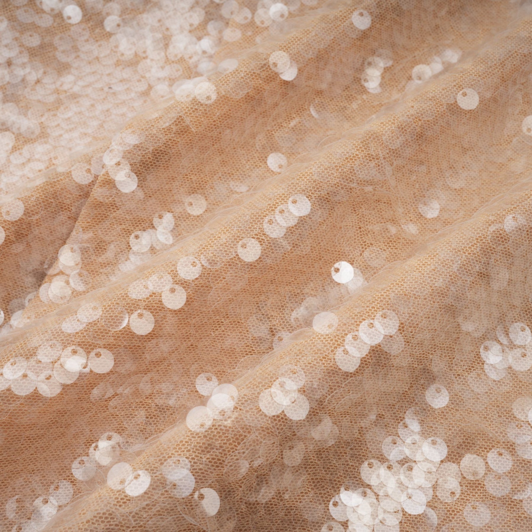 A white midi dress with faux pearl embellishments and sequin details on a female model