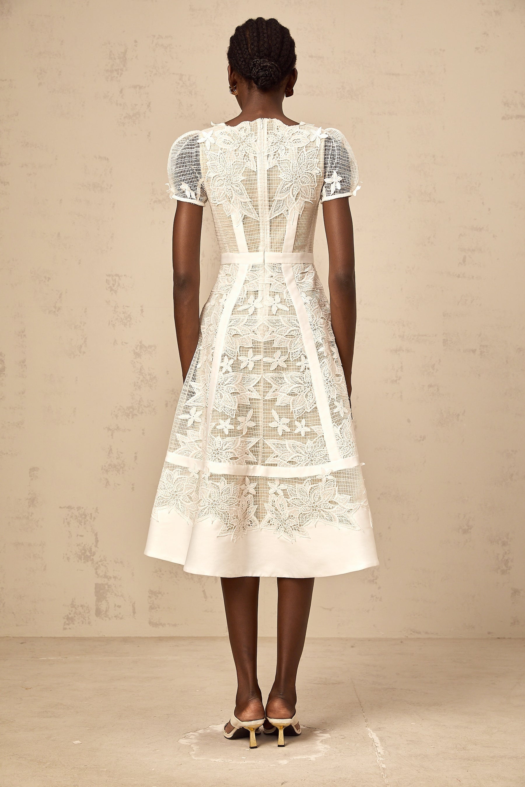 A white midi dress with floral embroidery details named Clémence