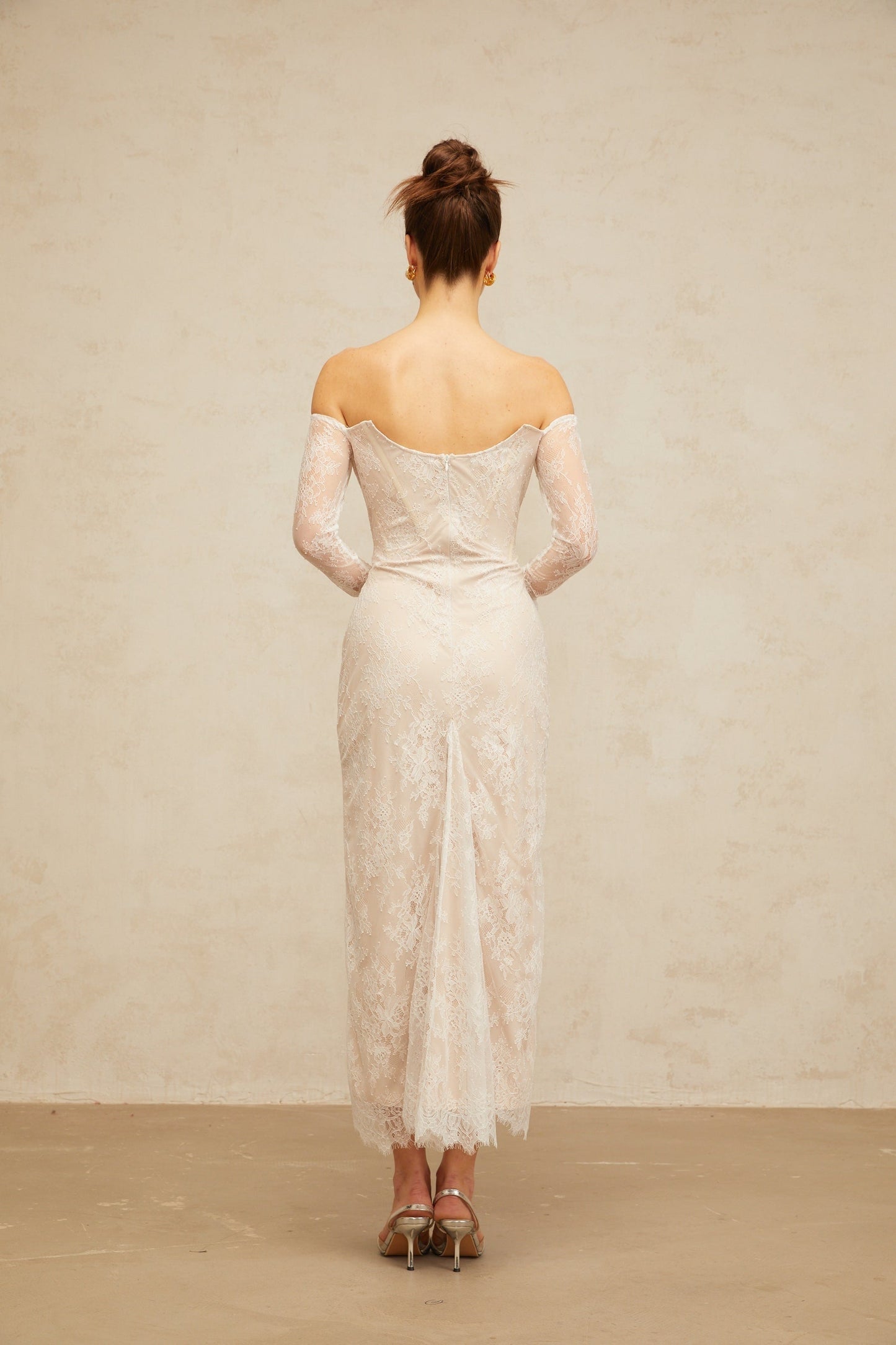 A white midi dress with floral lace embellishments named Enora