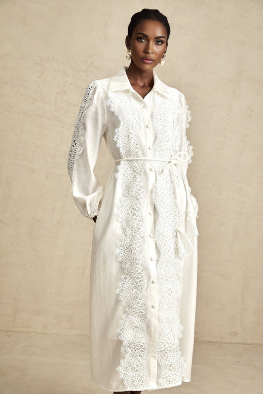A white midi dress with lace detailing and a tied waist named Colette