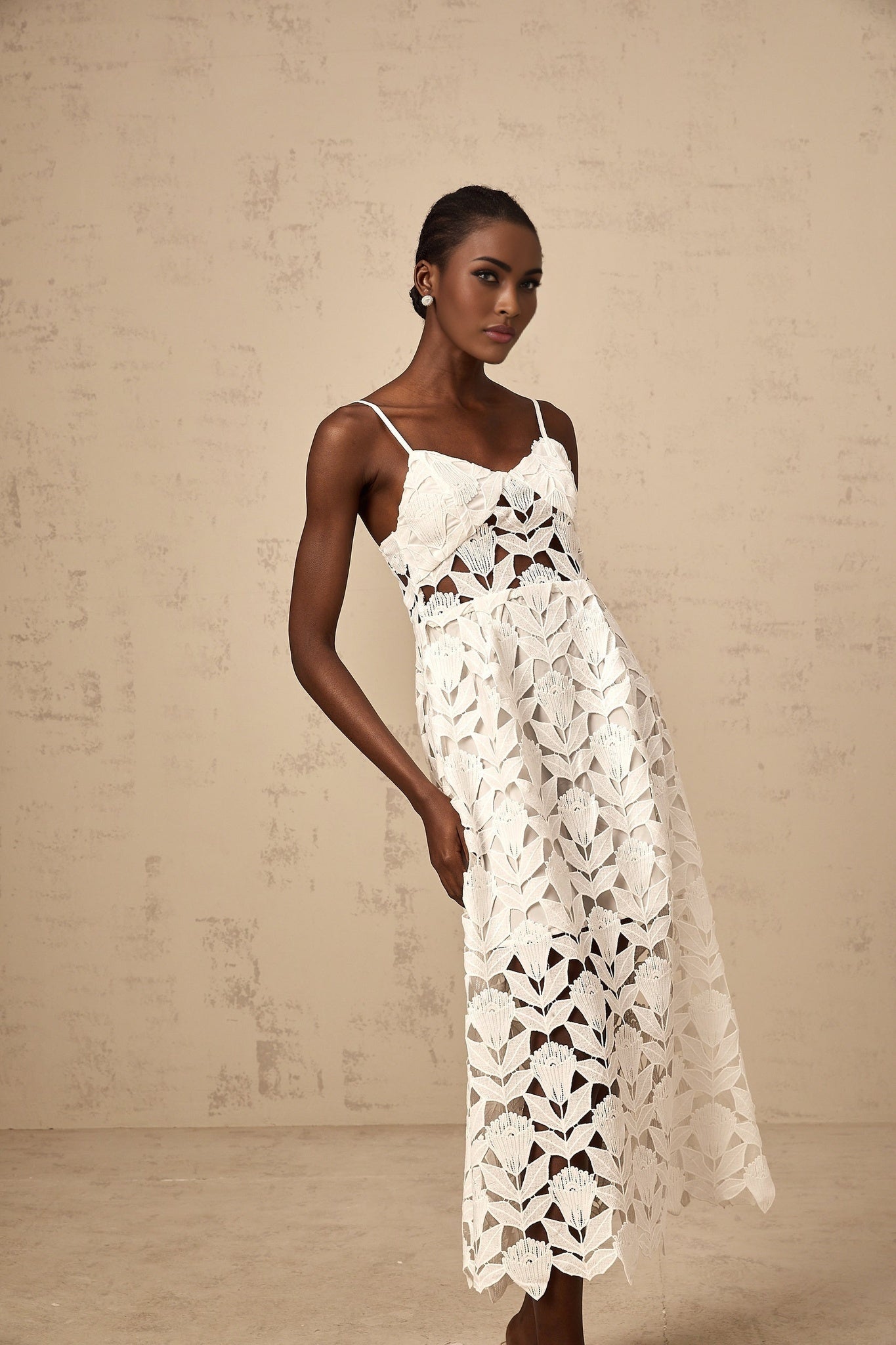 A white midi dress with lace detailing and cutout design named Delphine