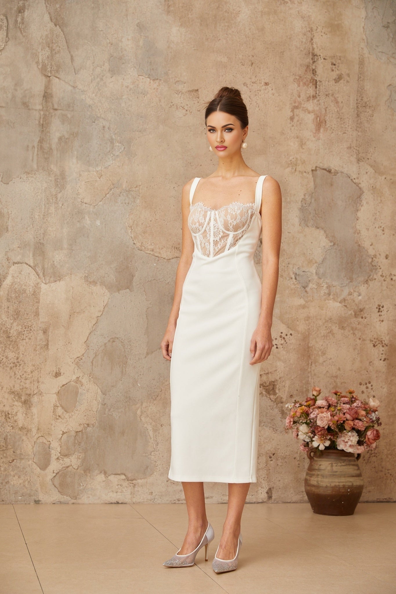 A white midi dress with lace panel details and a corsetstyle bodice