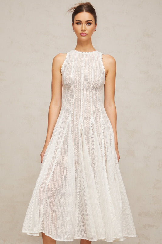 A white midi dress with puff sleeves and pointelle detailing named Helene