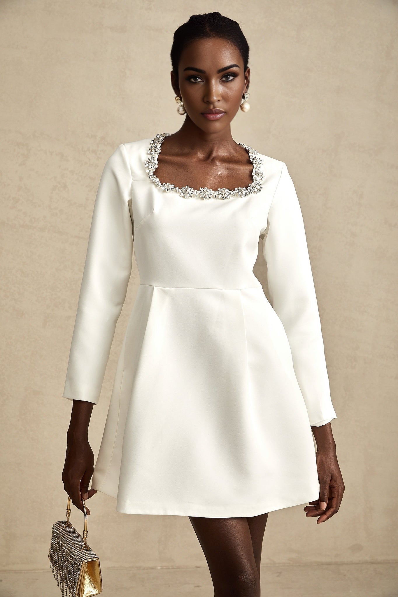 A white mini dress with crystal embellishments and an Aline silhouette called Angelique