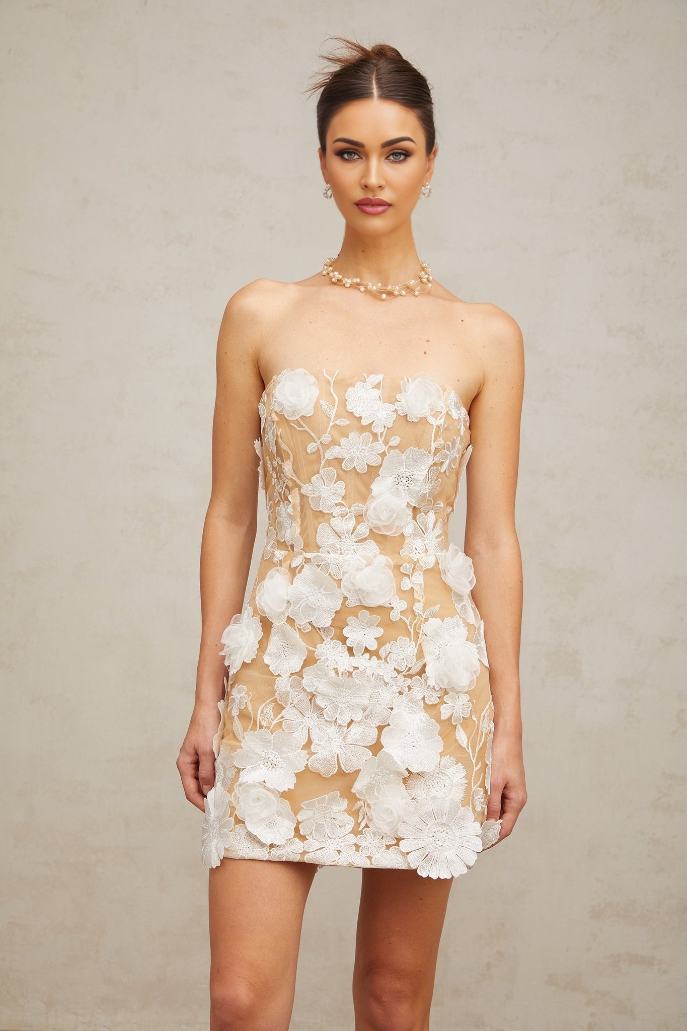 A white mini dress with floral appliques featuring a delicate Veronica flower design