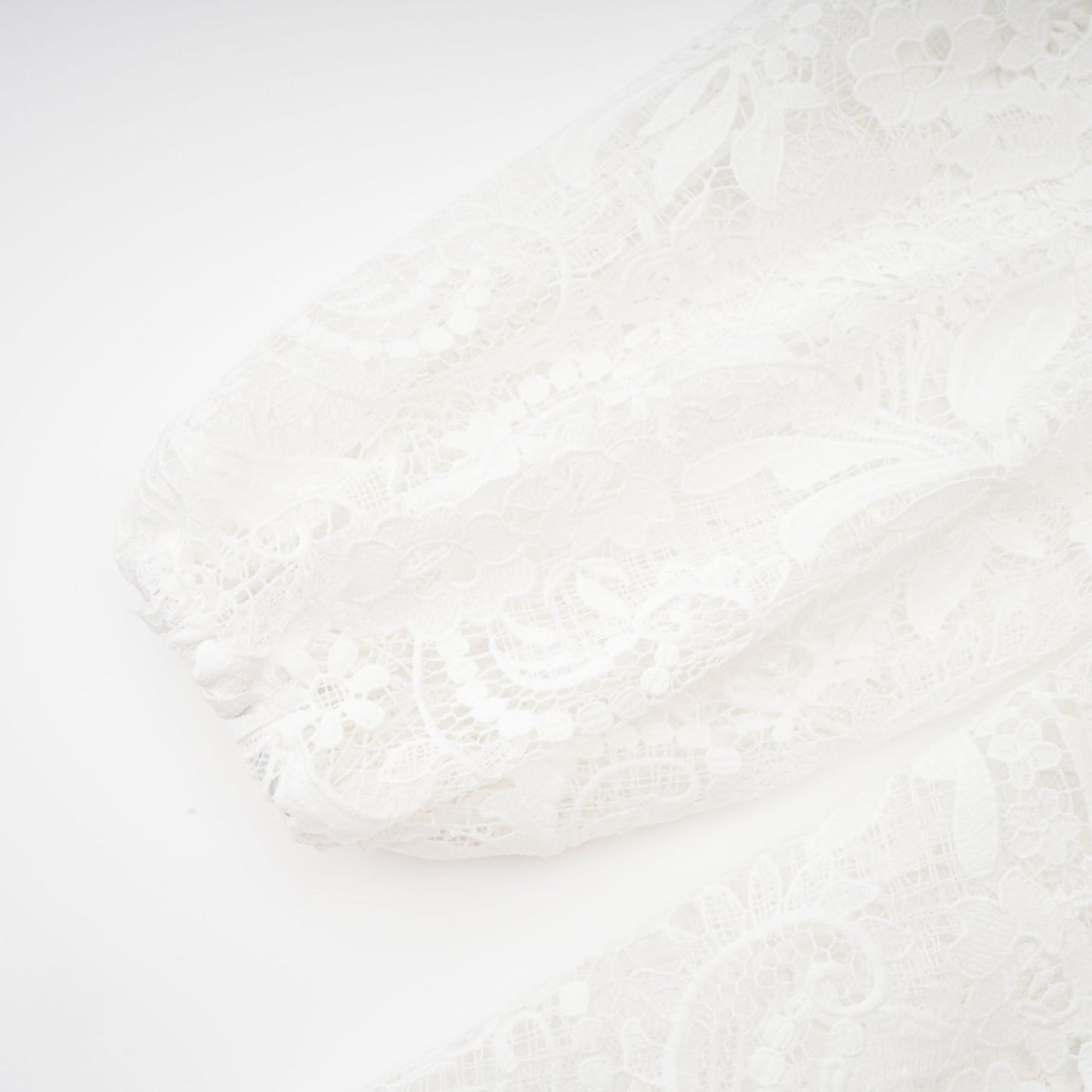 White Aline dress with crew neck long sleeves embroidered lace detail cutout design cinch waist flounce hem and front button closure Mini length in 70% Cotton 20% Terylene 10% Viscose