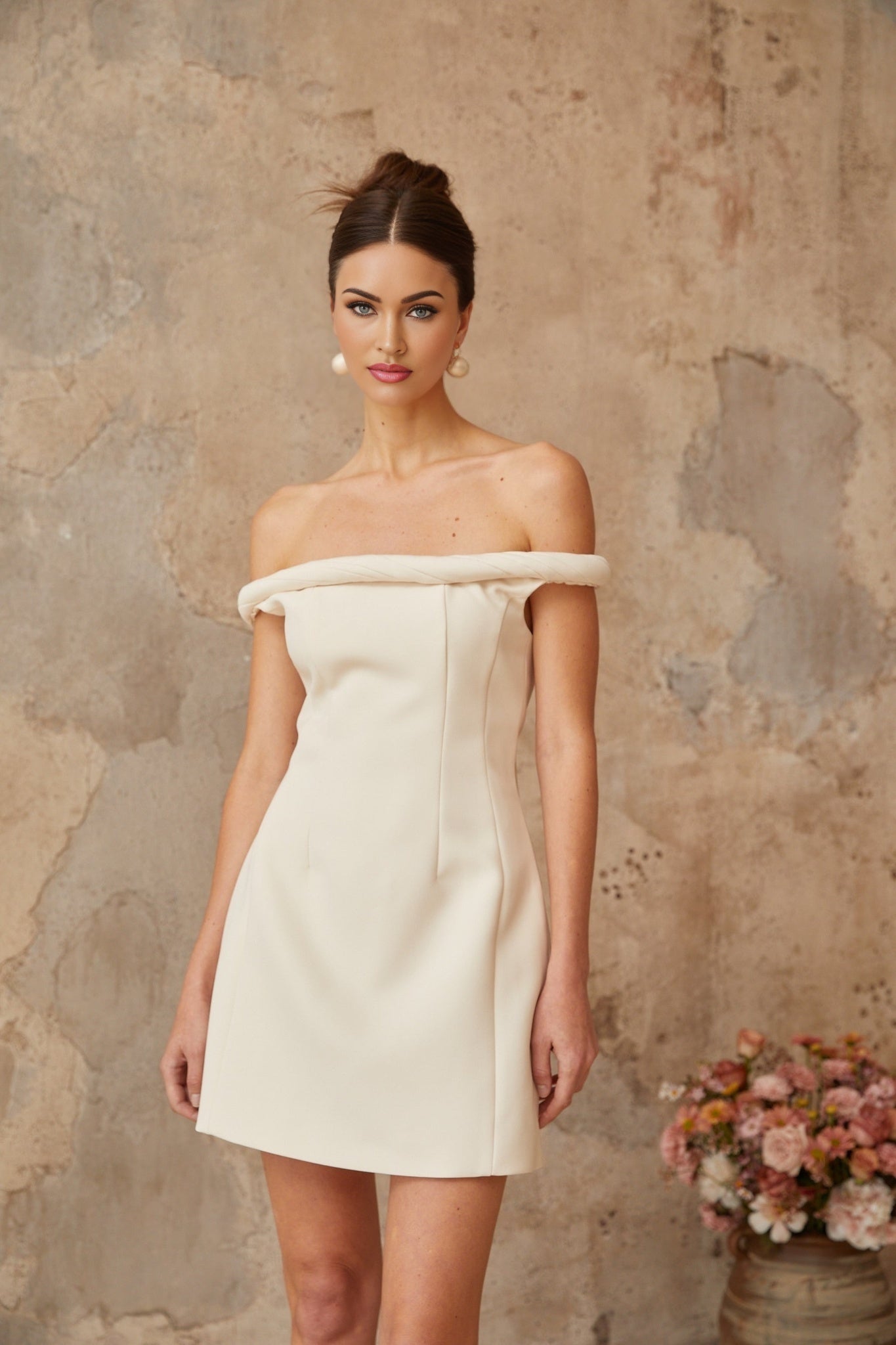 A white mini dress with puff sleeves and braided detailing featuring a short hemline and a fitted silhouette