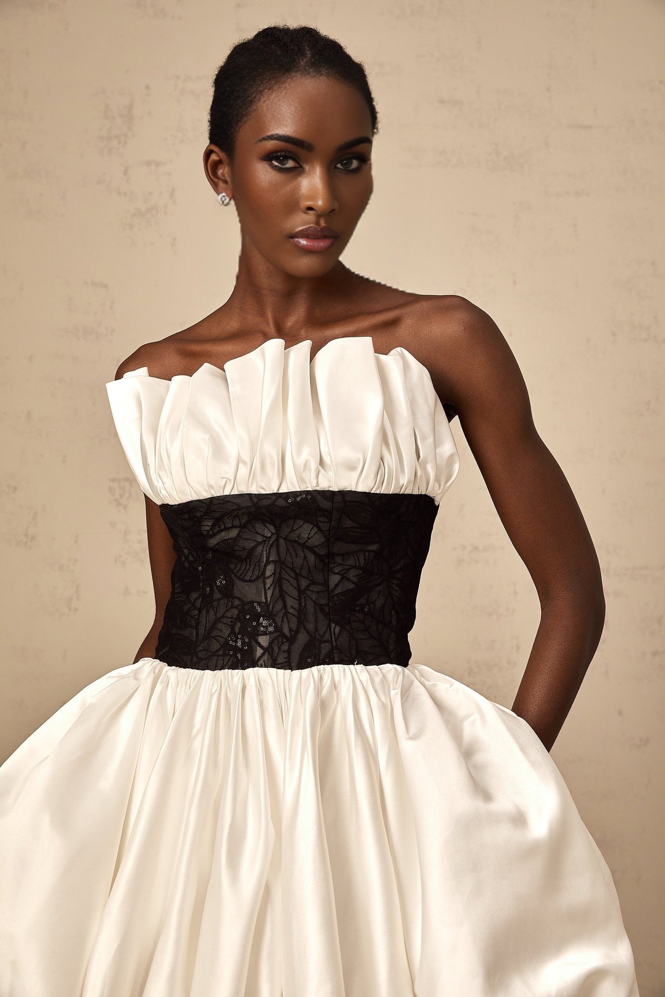 A white mini dress with puff sleeves featuring lace panelling and a satin finish