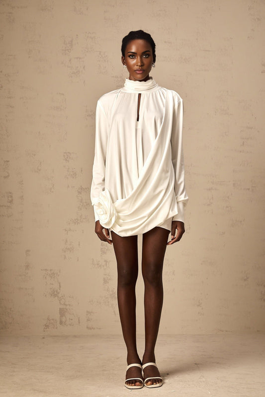 A white mini dress with ruched detailing and faux flower embellishments