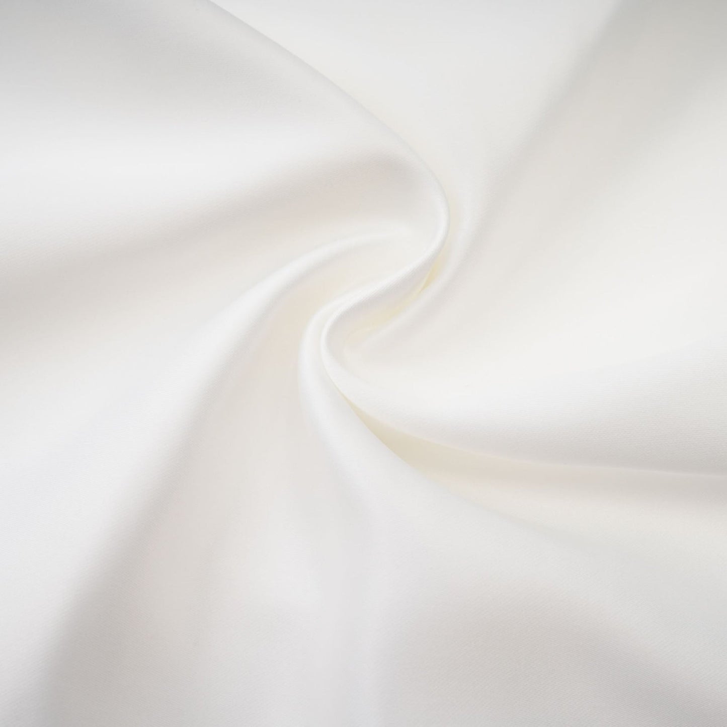 A white off the shoulder dress with flowing fabric hanging elegantly on a model